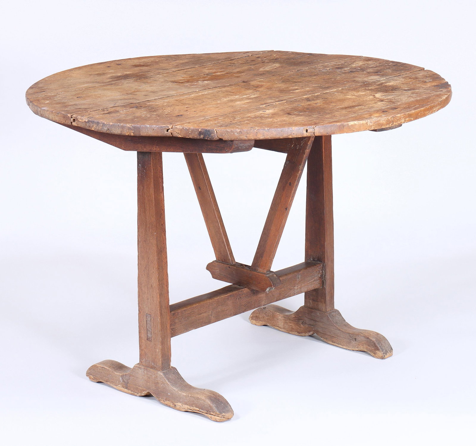 French Wine Tasting Table: French Wine Tasting Table having a round tilt-top and wishbone swivel support, over a trestle base, early 19th century. 27 1/2 x 38 in. (69.9 x 96.5 cm.)