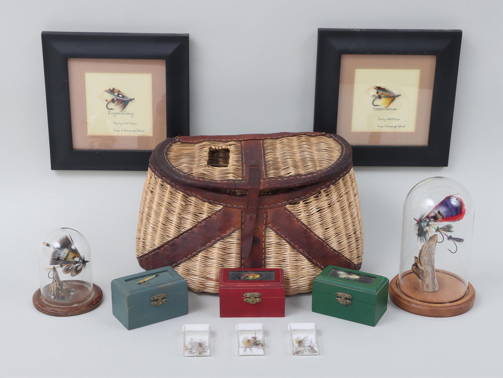 Group of (8) Fly Fishing Decorative Items: Group of (8) Fly Fishing Decorative Items to include: pair of framed salmon flies tied by F. McPhillips, comprising a ?Rogan?s Fancy? and a ?Green Parson?; (3) small painted boxes with a streamer on t