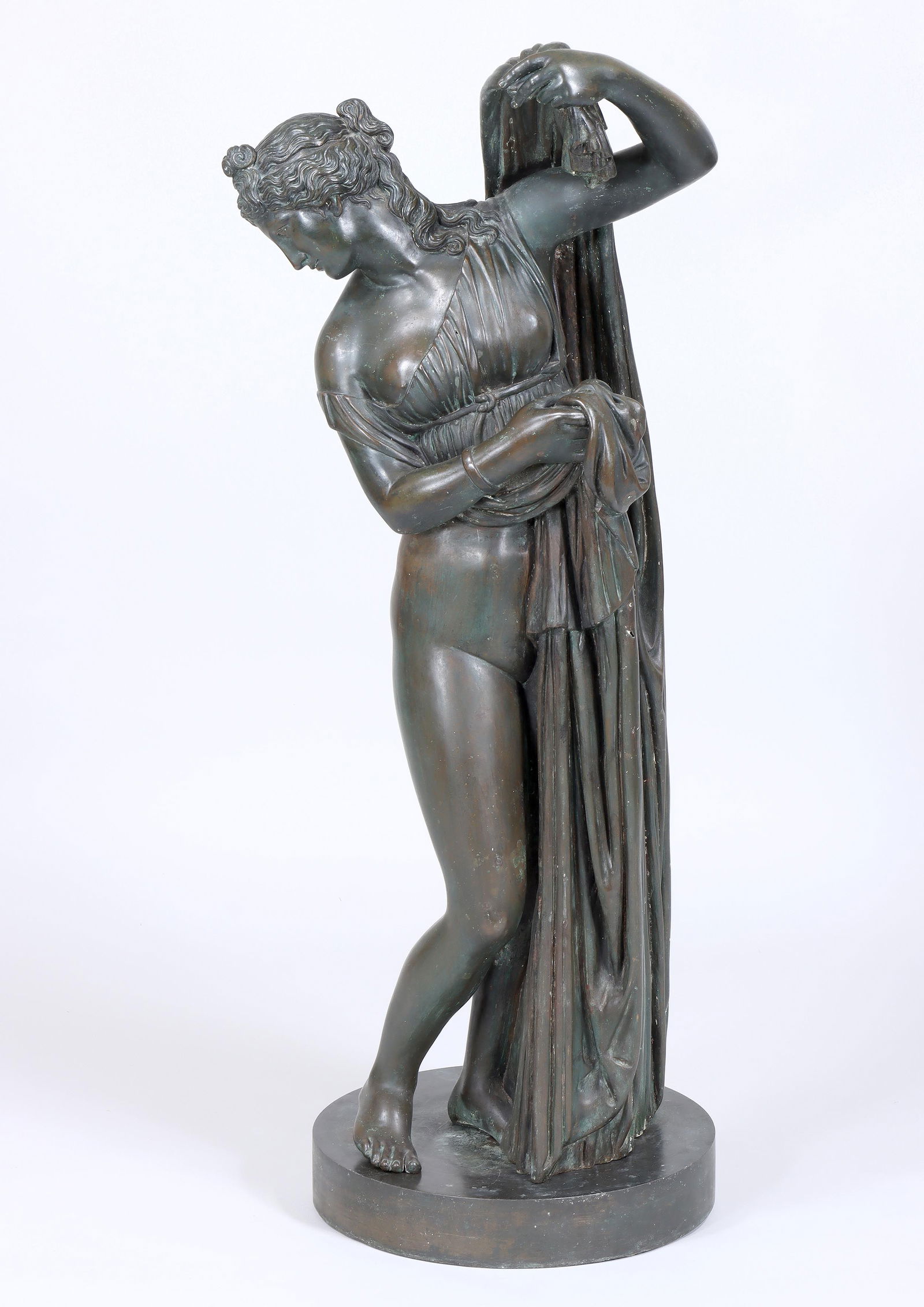 "Venus Callipyge", 19th Century Continental Bronze, After the Antique: "Venus Callipyge", After the Antique19th century Continental bronze with green and brown patinaon a circular weighted plinth, unmarked.Height 43 in. including base (109.2 cm.)