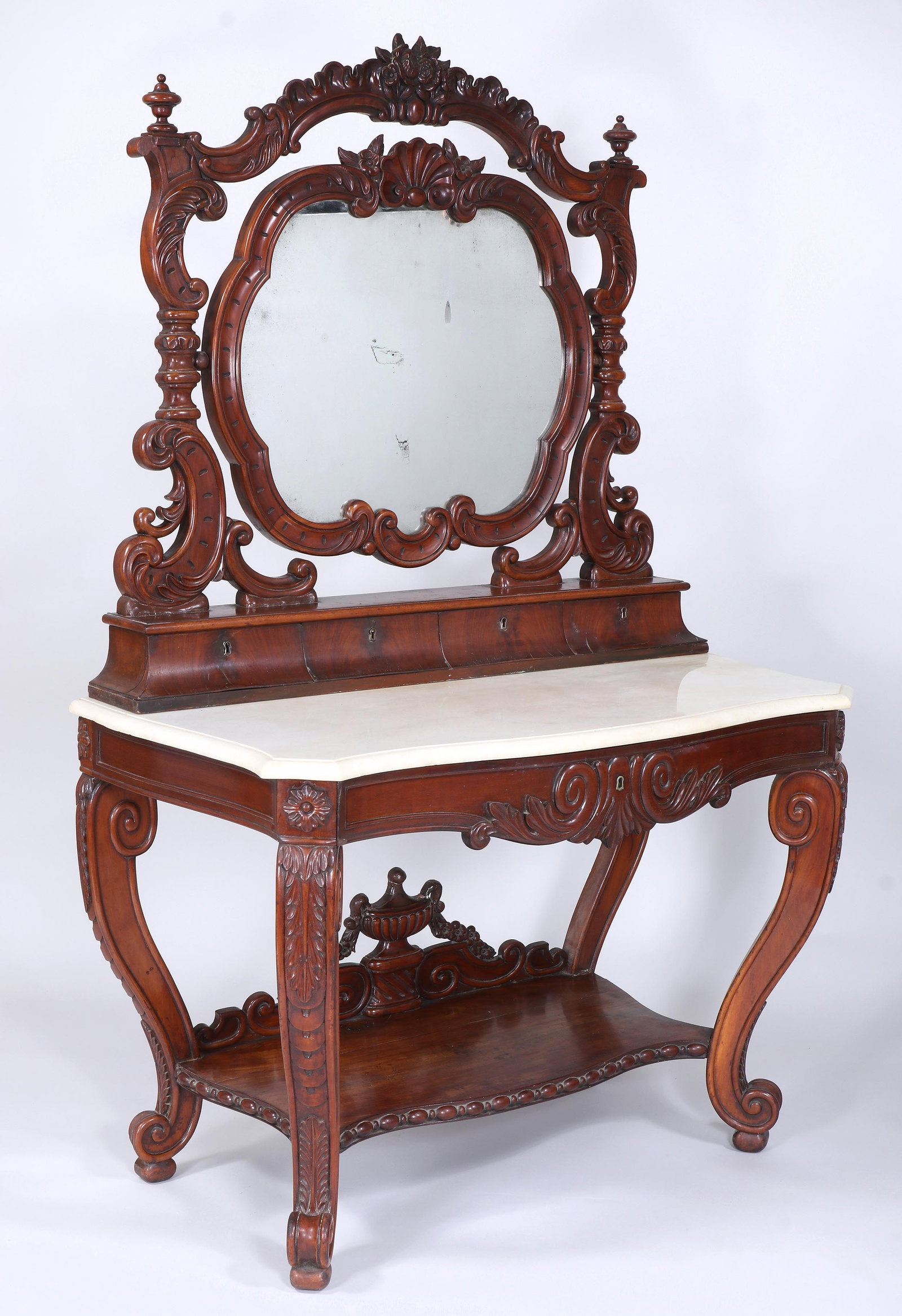 American Rococo Revival Mahogany Marble-Top Dressing Table: American Rococo Revival Mahogany Marble-Top Dressing Table the rocaille-carved mirror frame with a shell crest flanked by flowers, and conforming mirror support with floral crest flanked by urn finial