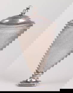 18th/19th century silver urn-form nutmeg grater.: 18th/19th century silver urn-form nutmeg grater.The hinged lid with double-ball finial, and the hinge at the base allowing the front half to open, revealing a pierced steel grate, unmarked.Provenance:
