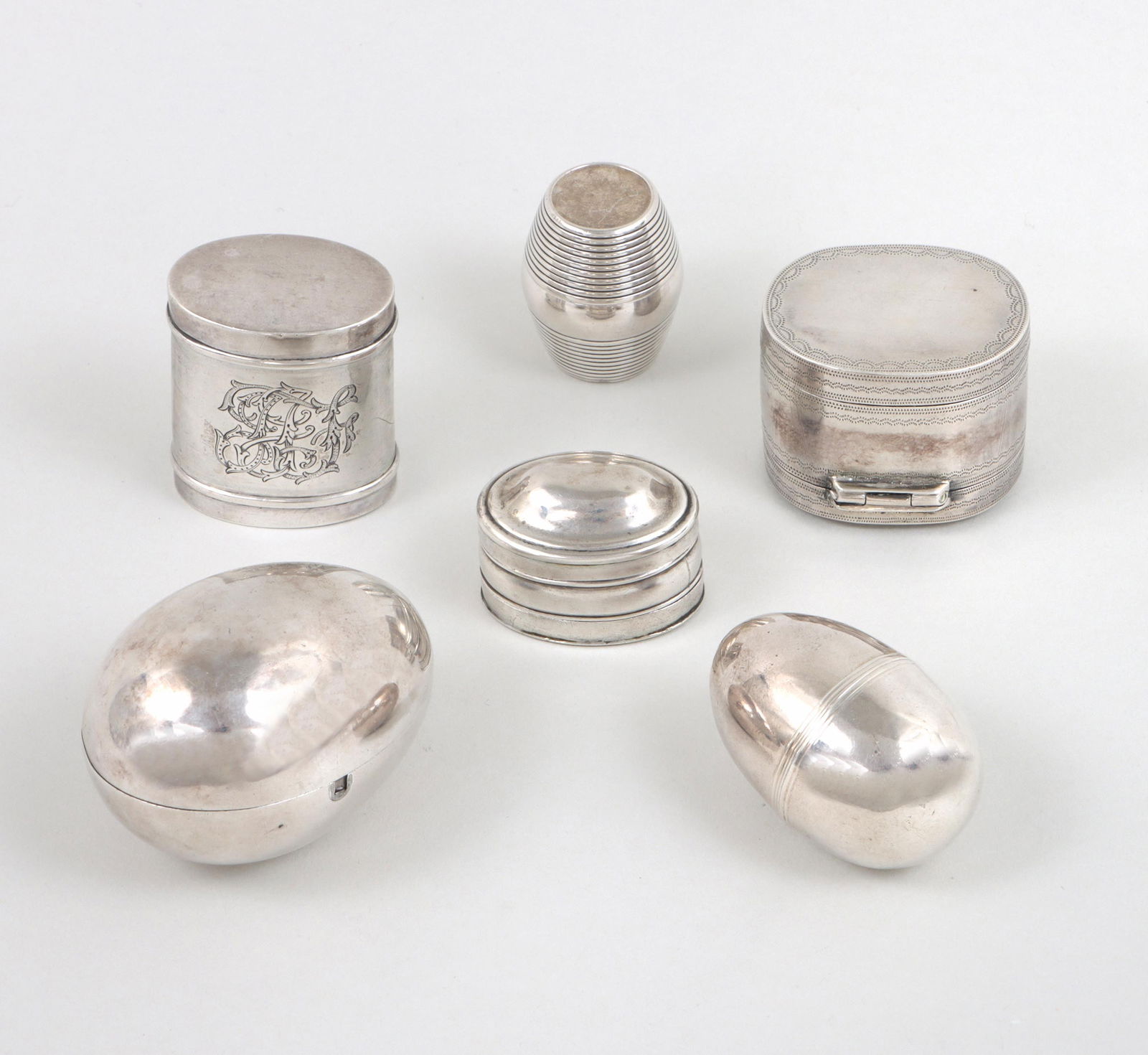 Group of (6) silver nutmeg graters.: Group of (6) silver nutmeg graters.All having silver cases with metal grates, to include: George III grater, Samuel Pemberton, Birmingham, 1798, of oblong form, having removeable domed lid and removea