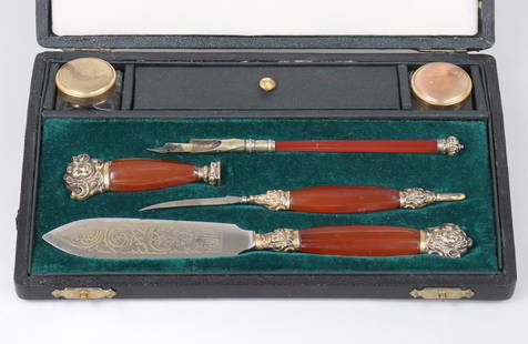 French silver-mounted carnelian handled desk set with writing implements, in original box: French silver-mounted carnelian handled desk set with writing implements, in original box, circa last quarter 19th century.To include: a pen, (2) letter openers, a sealing stamp, a glass ink sander an