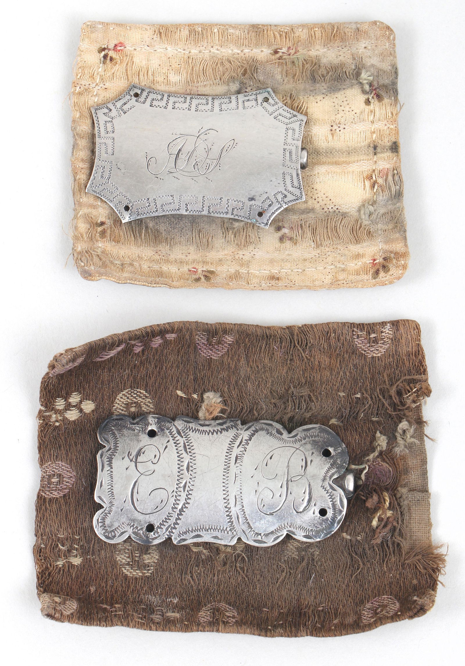 Group of (2) coin silver Federal period needle cases with original swatches, circa 1800.: Group of (2) coin silver Federal period needle cases with original swatches, circa 1800.Shaped borders with engraved decoration. Both with the original Federal period fabric swatches the needle cases