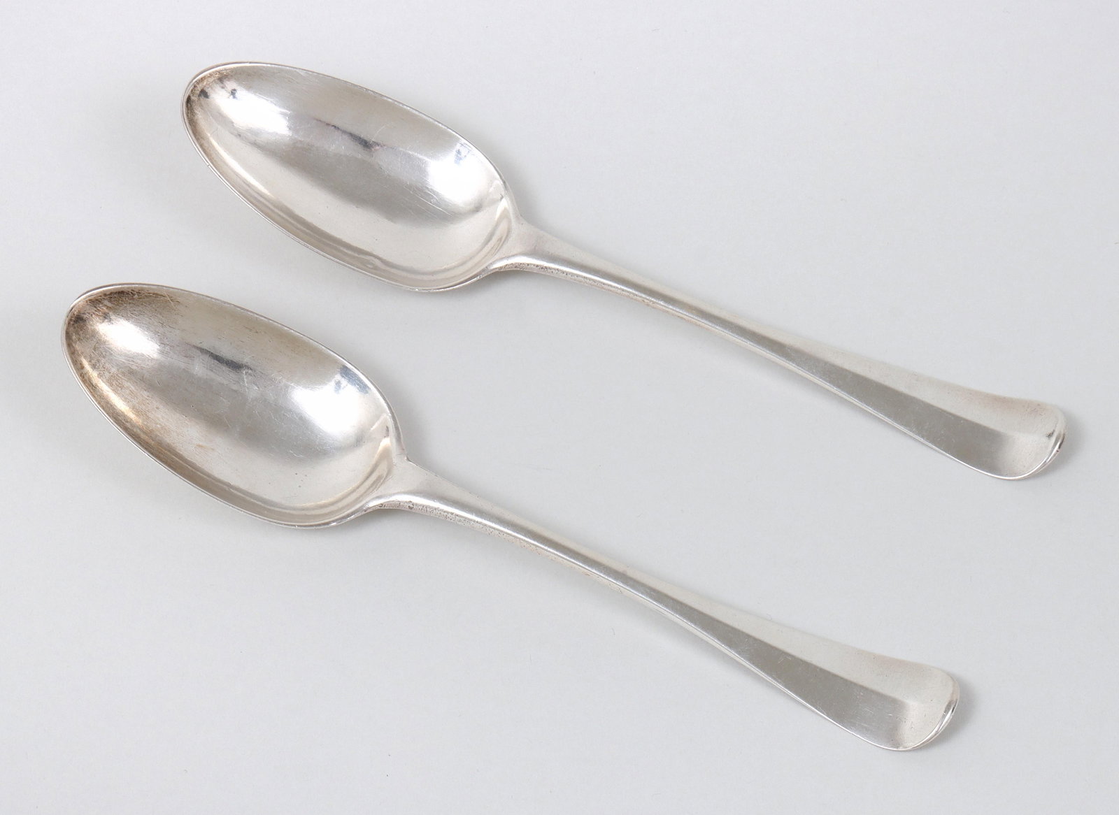Pair of American mid-rib tablespoons, maker "DC", not identified, circa 1770.: Pair of American mid-rib tablespoons, maker "DC", not identified, circa 1770. Well defined upturned handle tips and egg shaped Hanoverian bowls with molded bowl drops. Triple script monogram