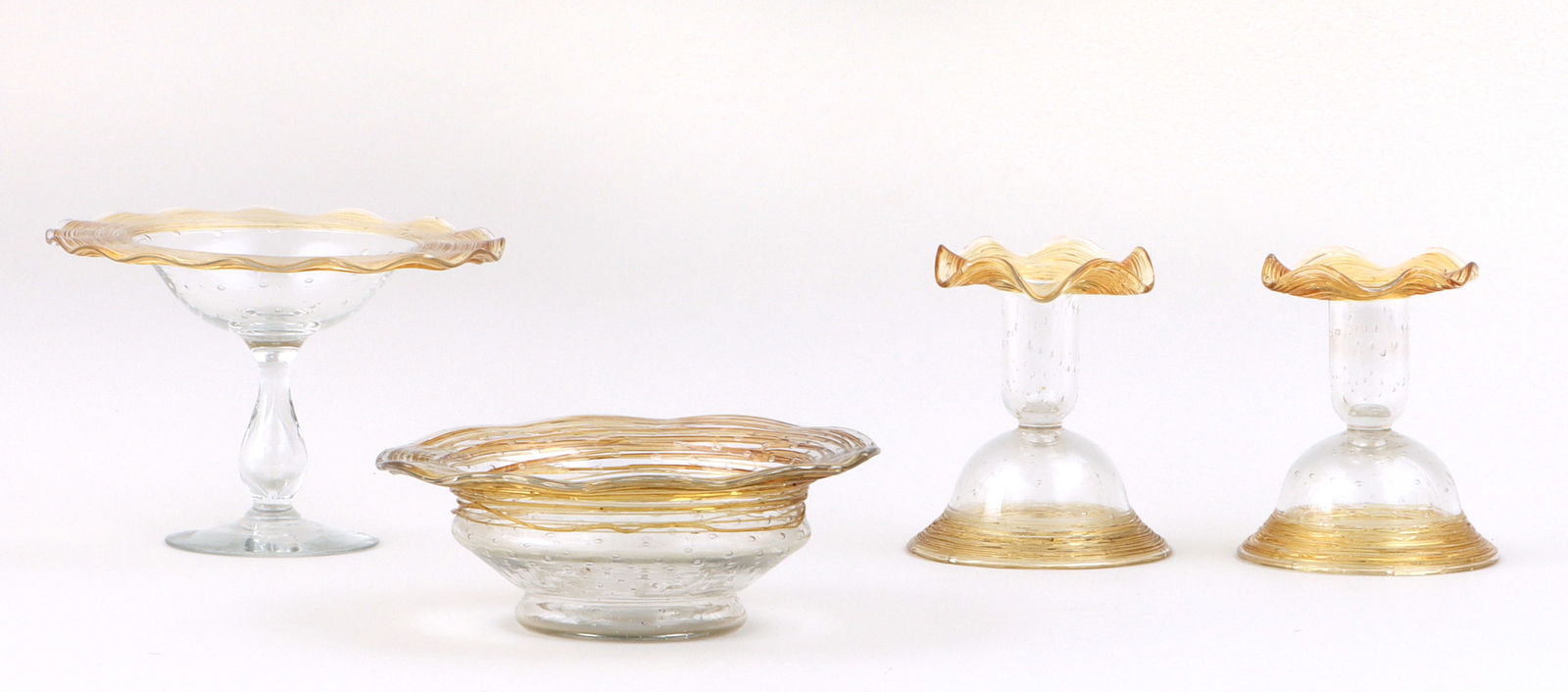Set of (4) Glass Table Articles: Set of (4) Glass Table Articlespossibly Steuben or Fry, having undulating rims with amber threading and bodies with controlled bubbles, to include: compote, (base with minor scratches and wear); pair