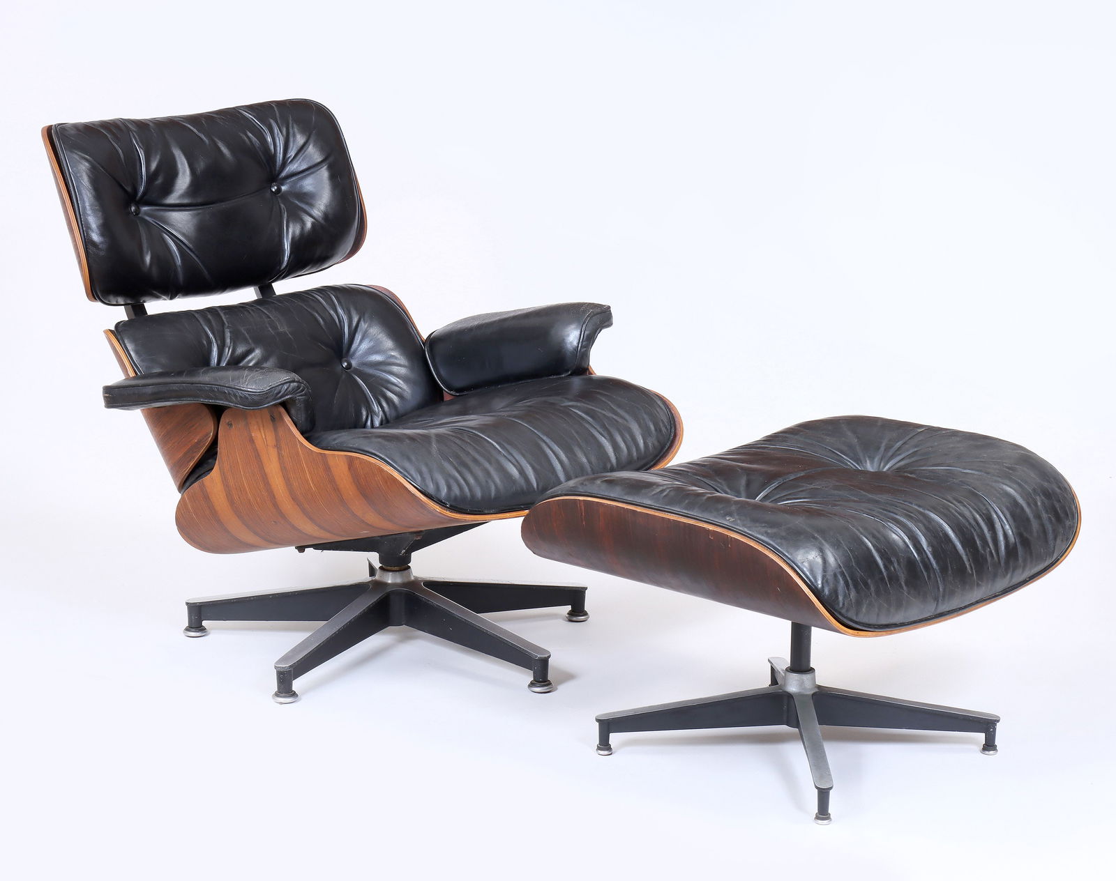 Charles and Ray Eames: Charles and Ray EamesAmerican, 1907-1978No. 670 Lounge Chair and No. 671 Ottoman for Herman Miller, 1975molded rosewood plywood, leather, enameled aluminum baseboth with labels to bottom, dated.Chair