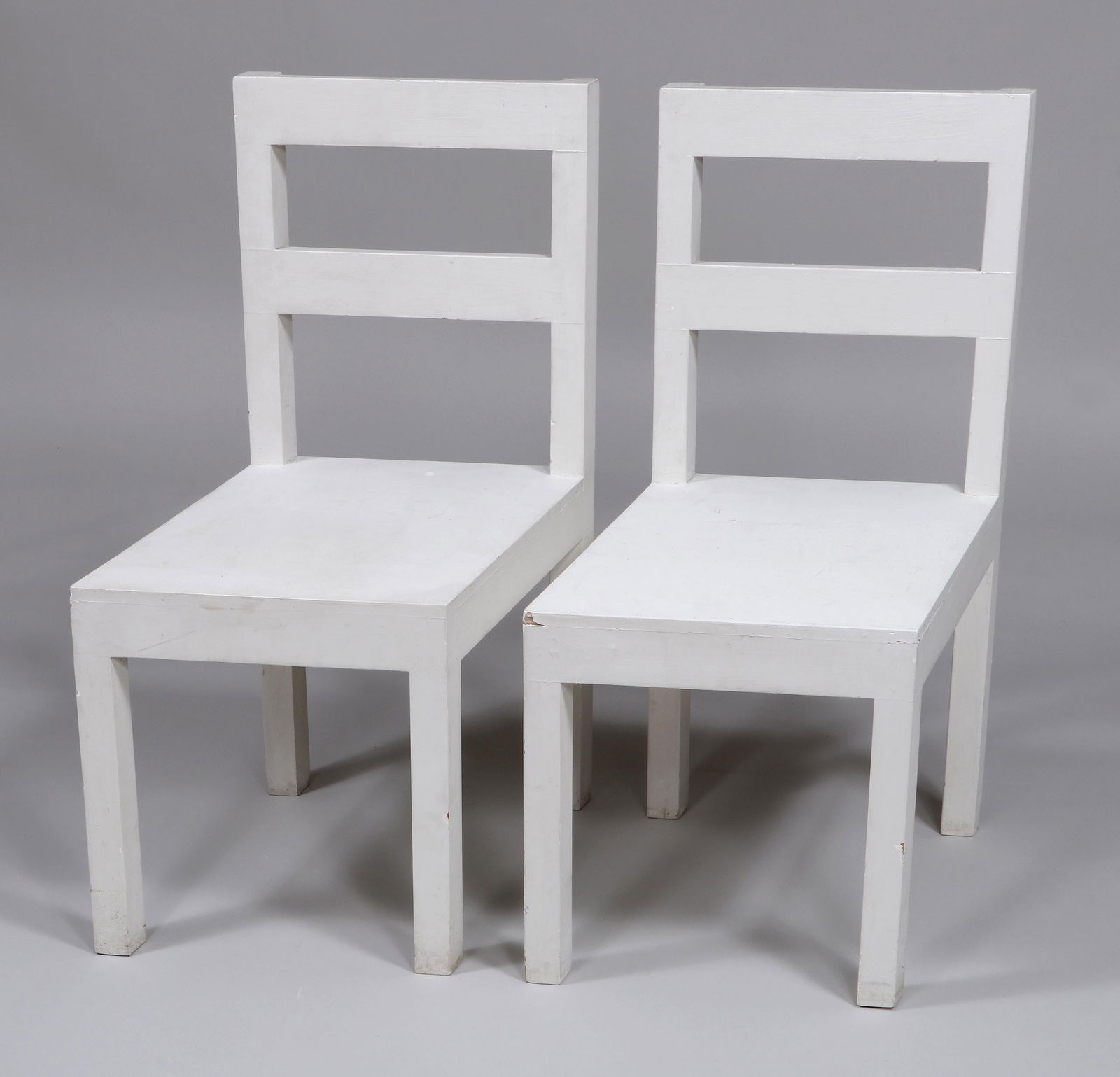 Pair of Contemporary Oblique-Angle Chairs: Pair of Contemporary Oblique-Angle Chairsin white paint.Overall 36 x 20 in. x 16 in. (seat) x 17 1/2 in.