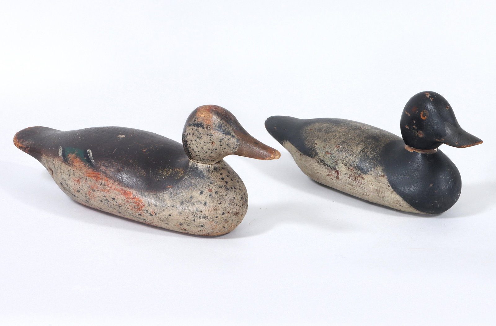 Group of (2) Mason Decoys: Group of (2) Mason Decoys to include: 1) Mason painted-eye standard grade drake broadbill. The paint appears original with missing neck filler. The bottom has a wood crack from breast to about center 