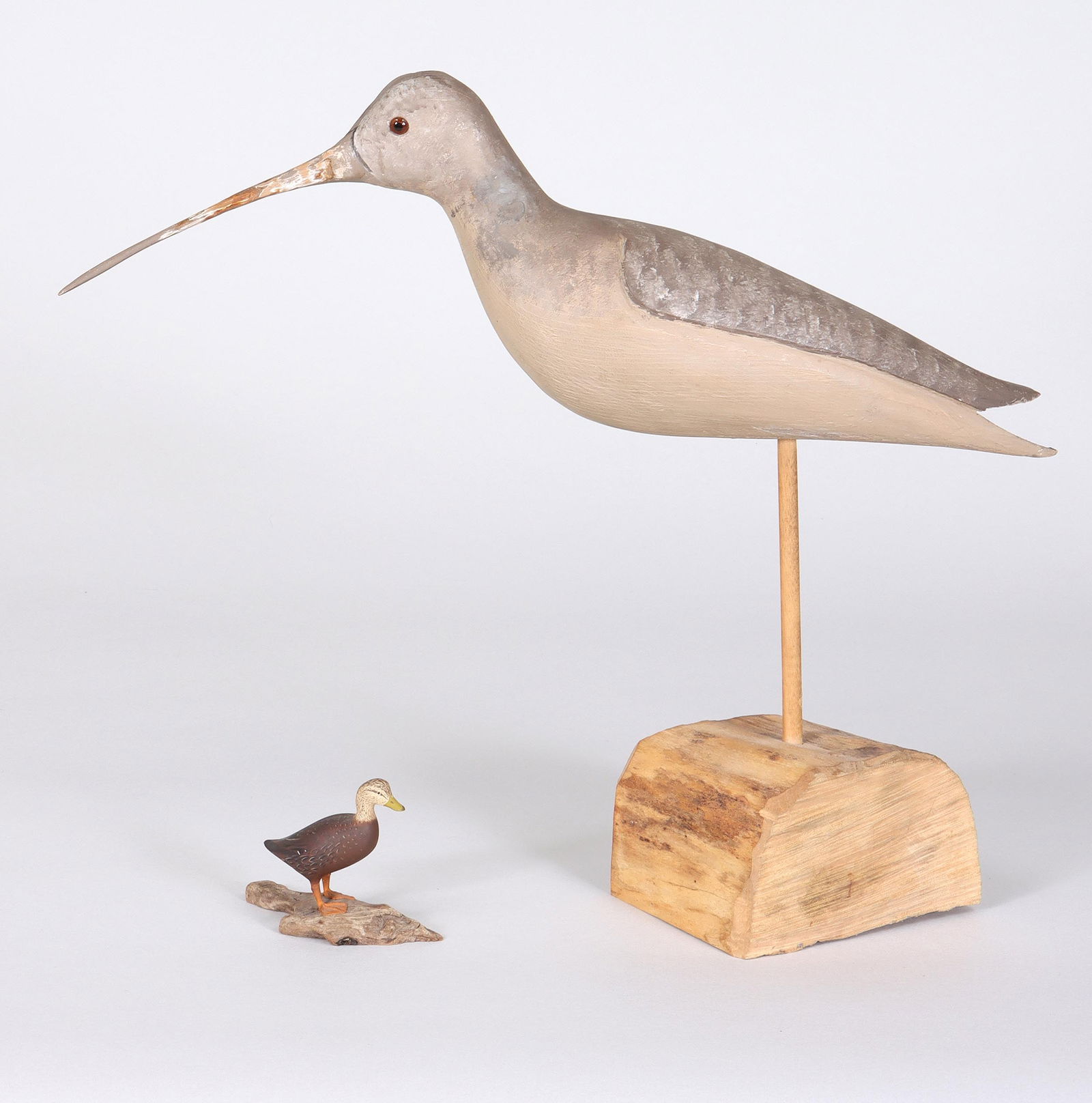 Group of (2) Decoys: Group of (2) Decoysto include: 1) Harold Nelson Gibbs (Rhode Island/Massachusettes, 1886-1970) miniature black duck, in excellent condition, on a driftwood stand. The bottom is marked in ink "Black Du