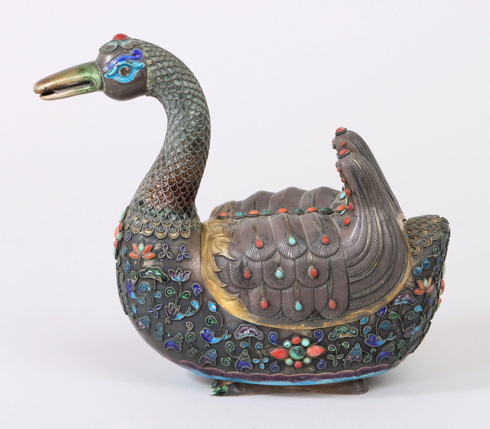 Chinese Silver Cloisonne Duck: Chinese Silver Cloisonne Duckhaving inlaid coral and turquoise cabochons, body with scrolled lotus plants, shells, and fish, and gilt wings lifting to reveal an interior compartment, incised numbers o