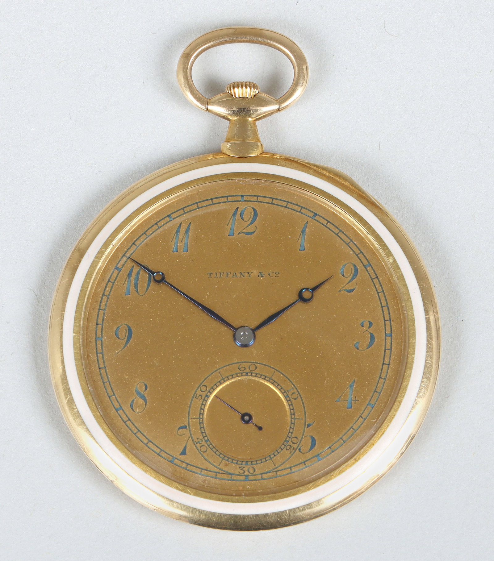 Tiffany & Co. Enameled 18k Gold Ultra-Thin Pocket Watch: Tiffany & Co. Enameled 18k Gold Ultra-Thin Pocket Watchmovement and case no. 10203, the dial with Arabic numerals, blued steel hands, and a sub-dial for seconds at six o'clock, the case with white ena