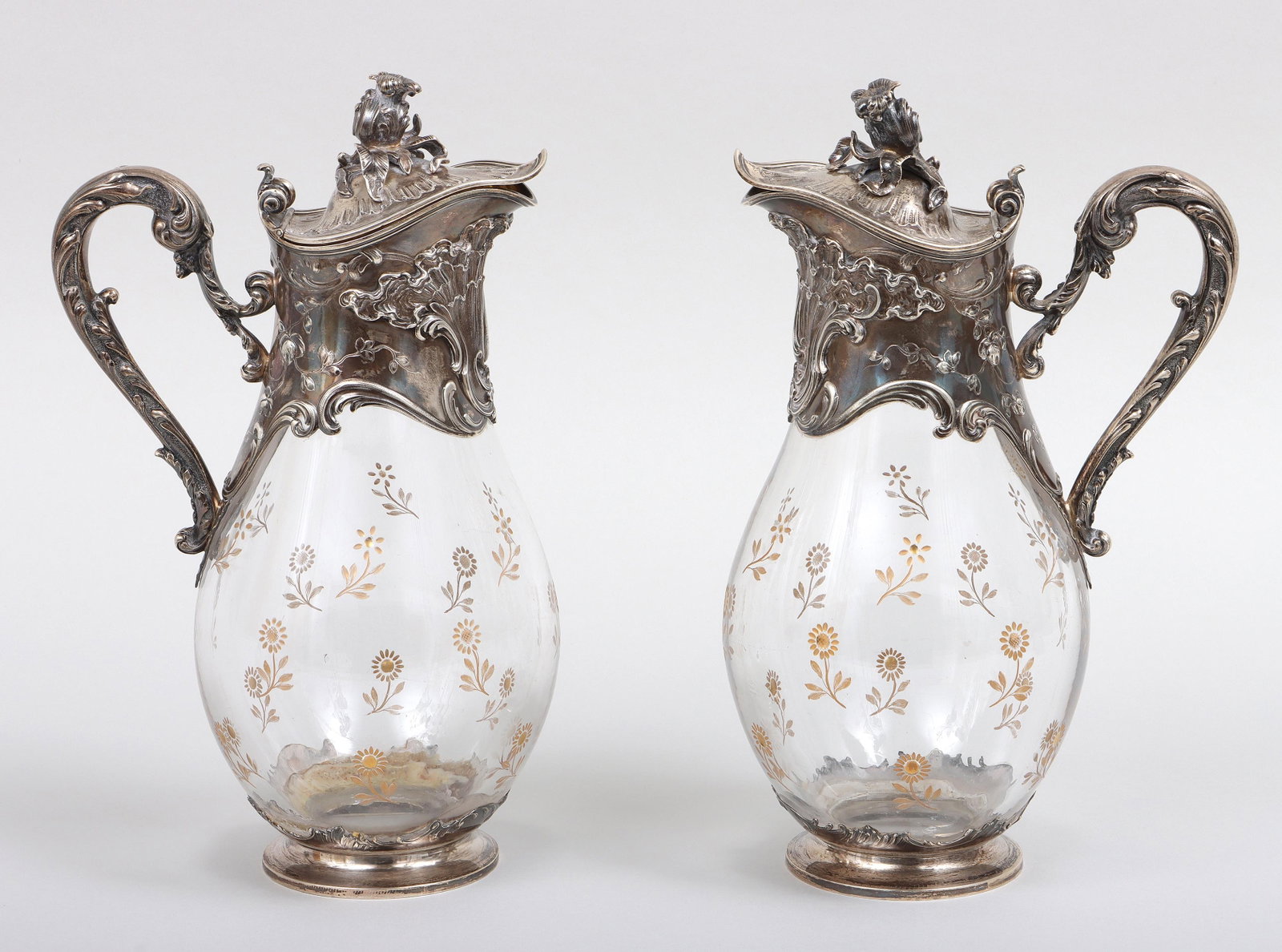 Maison Cardeilhac, Paris, .950 Silver-Mounted Claret Jugs: Pair of French .950 Silver-Mounted Etched Glass Claret Jugs Maison Cardeilhac, Paris, late 19th/early 20th century the silver mounts having rocaille design with shells, foliate scrolls and vines, on g
