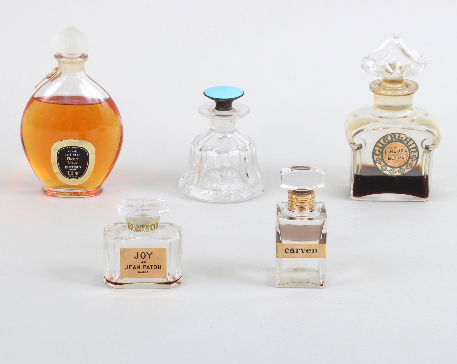 Group of (5) Glass Perfume Bottles: Group of (5) Glass Perfume Bottlesto include: bell-form cut-glass bottle having a sterling silver-mounted stopper with enamel guilloche on top, marked "Sterling" on silver mount and incised "19" on si