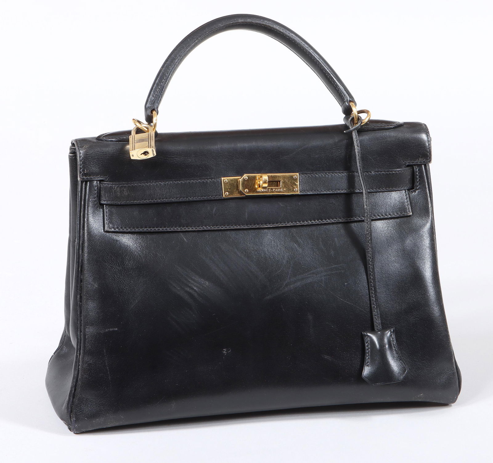 Hermes Kelly Sellier Black Leather Handbag: Hermes Kelly Sellier Black Leather Handbagsize 32, with goldtone hardware, having lock, removeable clochette with pair of keys inside, and a flap closure with rotating hardware, the interior having on