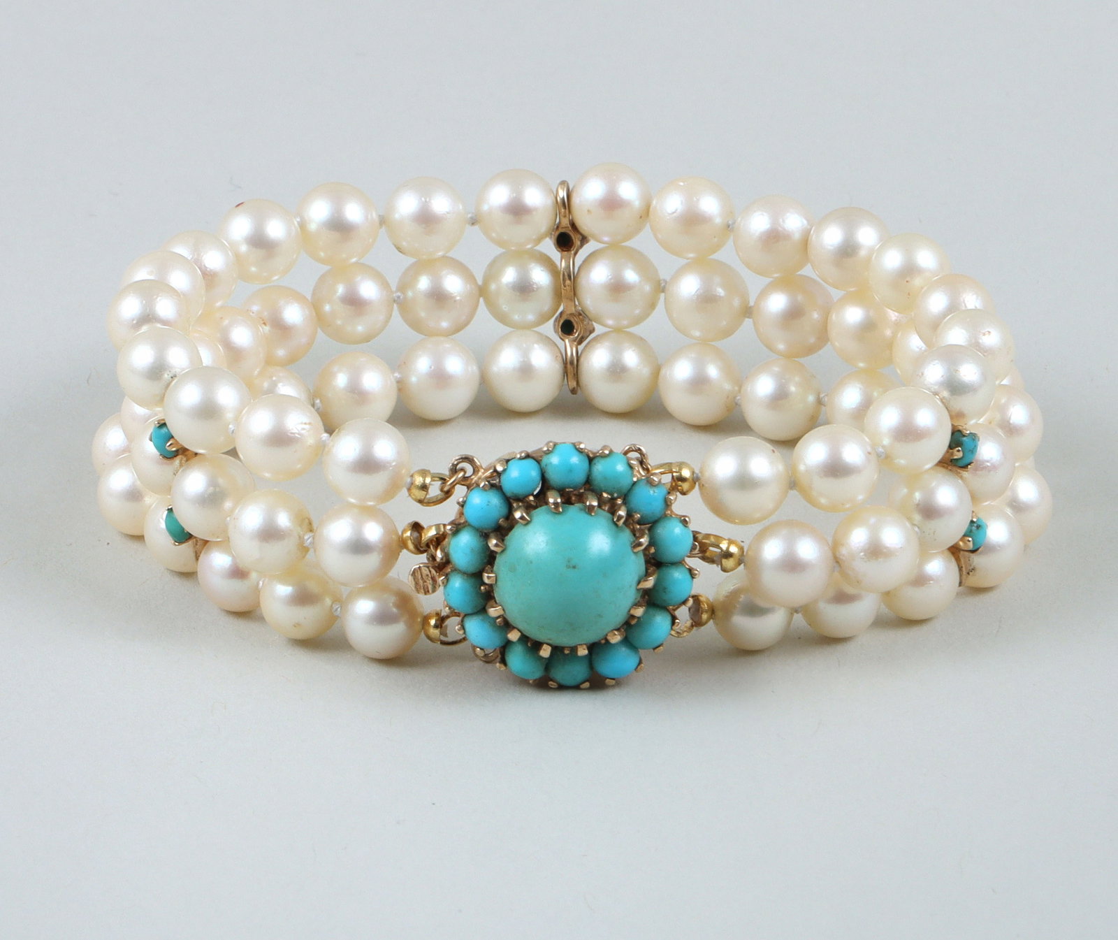 Triple-Strand Pearl, Turquoise, and 14k Gold Bracelet: Triple-Strand Pearl, Turquoise, and 14k Gold Bracelet having what appear to be cultured pearls, all approximately 7mm in diameter, (3) 14k spacer bars, each with (2) turquoise cabochons, and a 14k cla