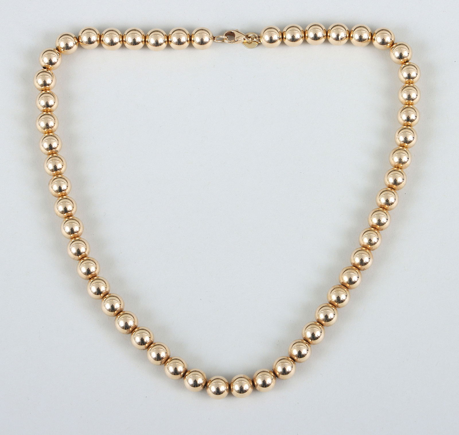 Tiffany & Co. 14k Gold Bead Necklace: Tiffany & Co. 14k Gold Bead Necklaceall beads approximately 8mm in diameter, marked on clasp and on round tag next to clasp.Length (open) 18 in. (45.7 cm.); approximate weight 29.8 dwt.