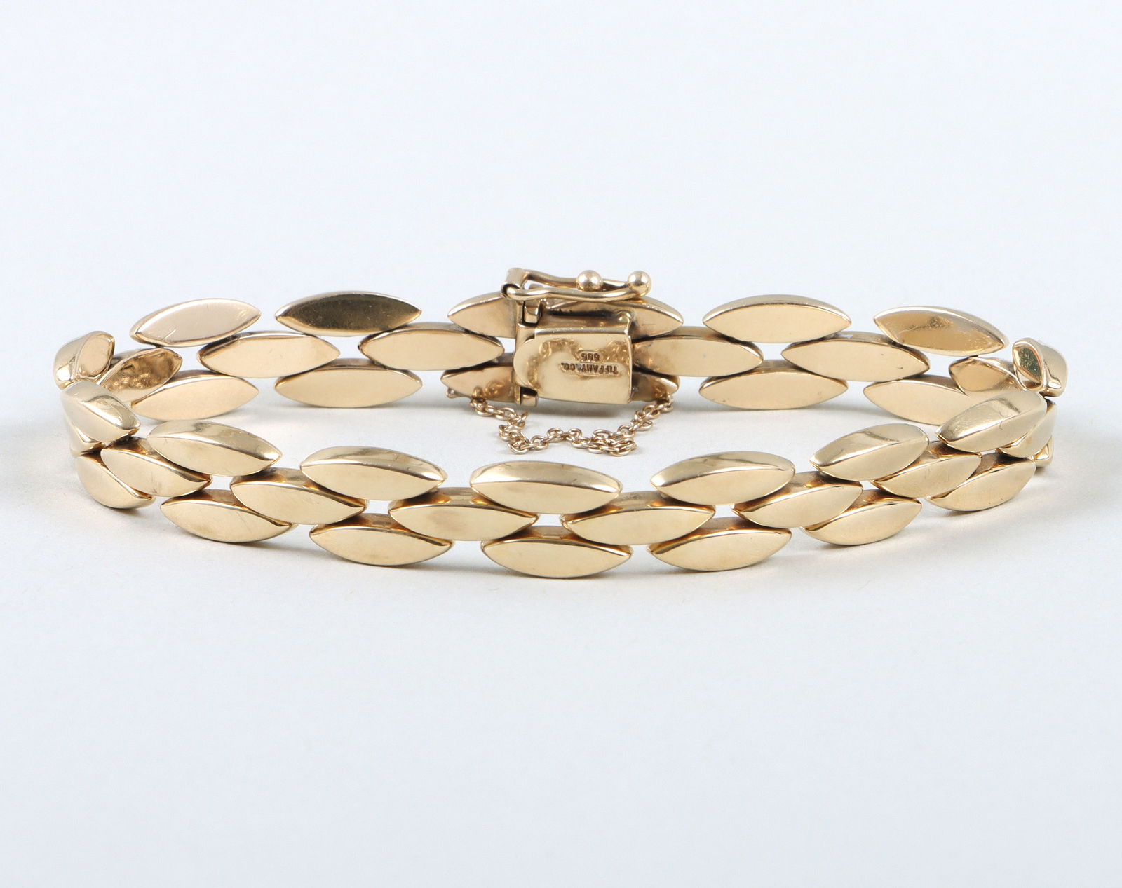 Tiffany & Co. 14k Gold Chain-Link Bracelet: Tiffany & Co. 14k Gold Chain-Link Bracelethaving a panther-style chain with marquise-form links, marked on clasp; along with a Tiffany & Co. pouch having a snap closure.Length (open) 8 in. (20.3 cm.);