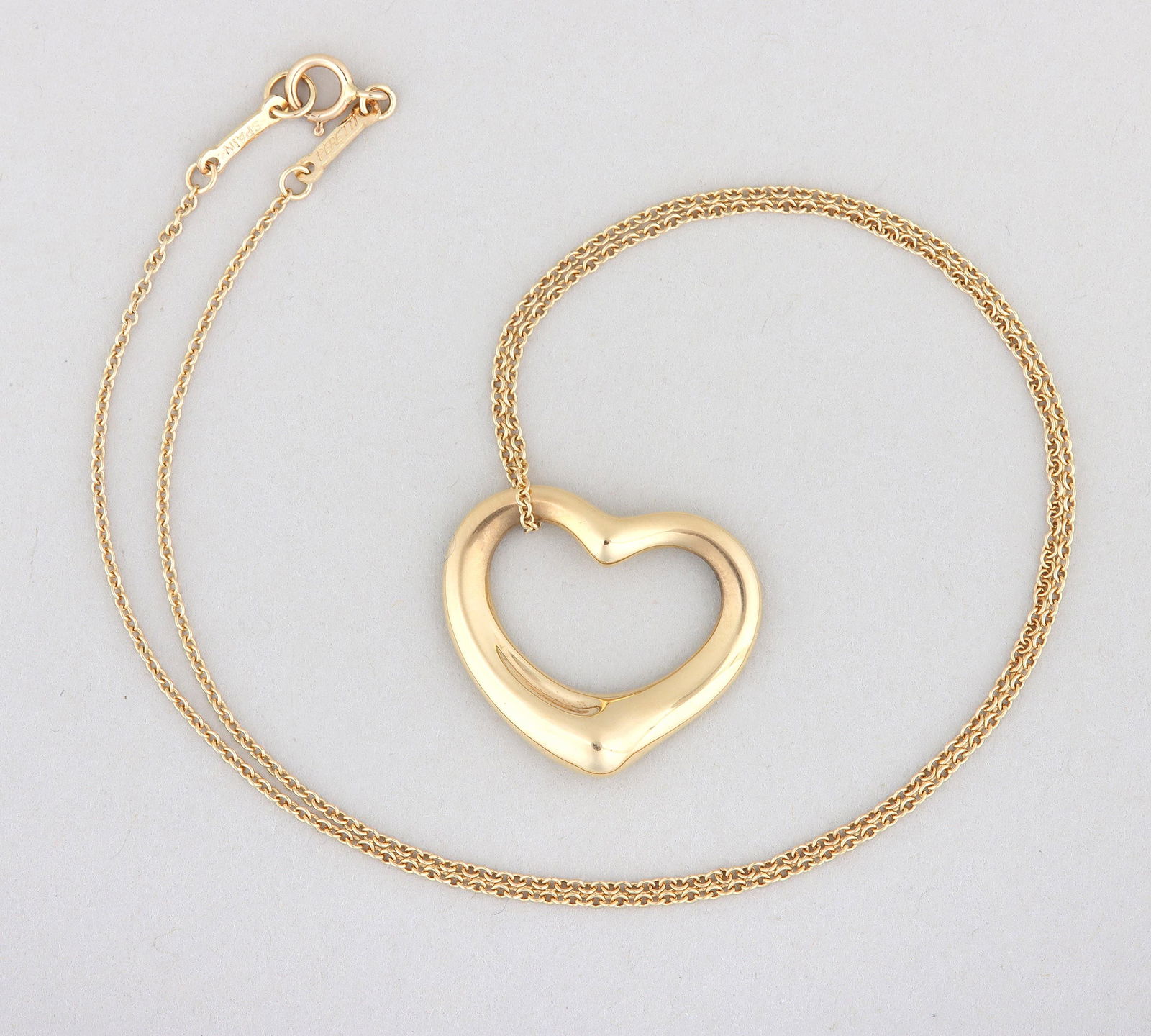 Elsa Peretti for Tiffany & Co. 18k Gold "Open Heart" Necklace: Elsa Peretti for Tiffany & Co. 18k Gold "Open Heart" Pendant Necklacewith a pierced heart-form pendant on a fine cable chain, signed and marked on pendant and clasp; along with a Tiffany pouch having