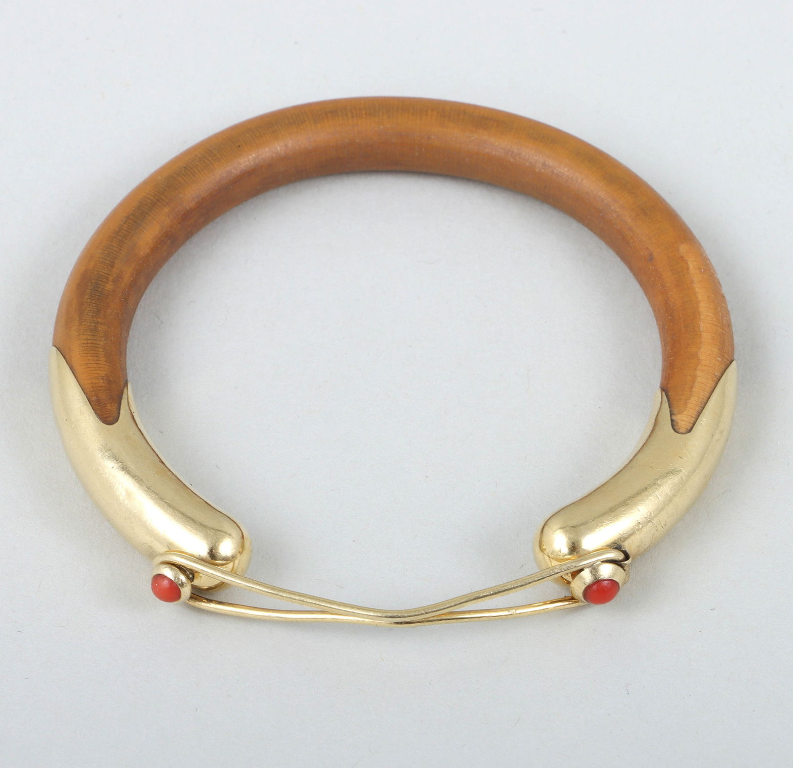 Elsa Peretti for Tiffany & Co. Coral, 18k Gold, and Bamboo Bangle: Elsa Peretti for Tiffany & Co. Coral, 18k Gold, and Bamboo Banglethe bamboo bangle having an 18k gold hook-and-eye clasp with (2) round coral cabochons in raised bezel settings, marked and signed insi