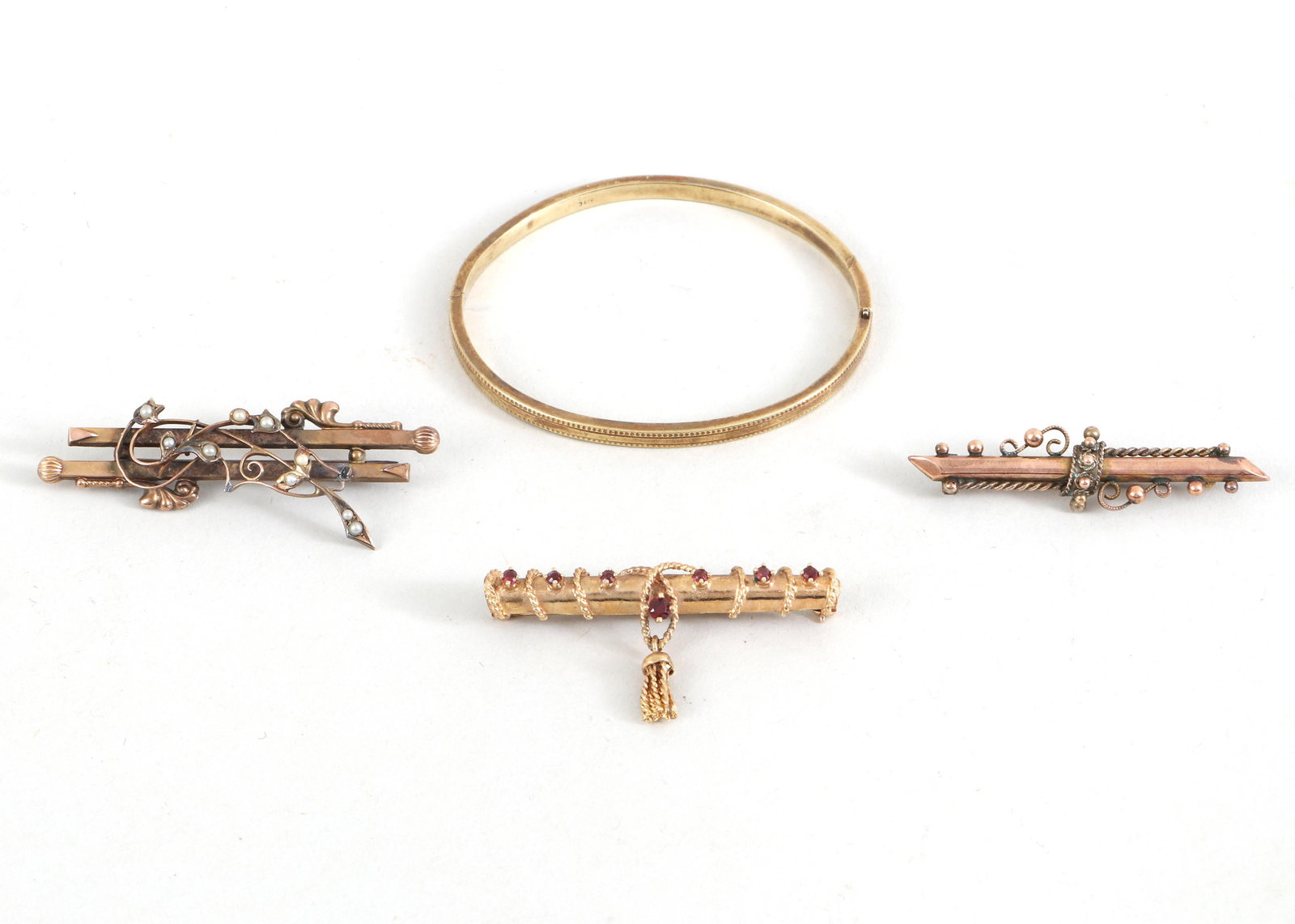 Group of (4) Gold Jewelry: Group of (4) Gold Jewelry to include: 14k child's bangle with millegrain borders, partial mark inside; 14k bar pin with (7) round-cut red garnets in prong settings, applied rope twist, and a tassel-fo