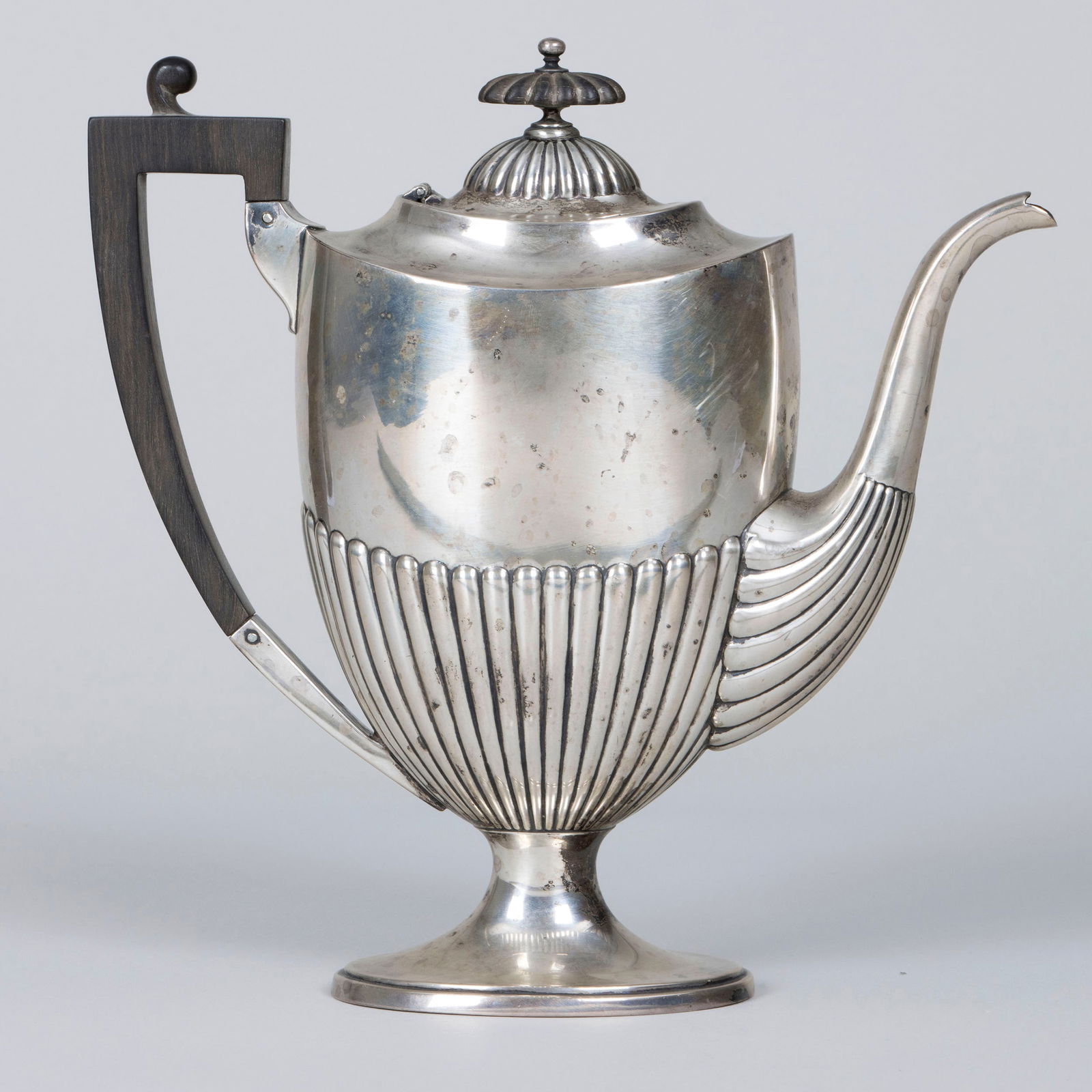 Sterling Footed Coffeepot, J.E. Caldwell & Co.: American Sterling Silver Footed CoffeepotWhiting Mfg. Co. for J.E. Caldwell & Co., late 19th/early 20th centuryhaving stop-reeded body with wood handle and hinged lid with reeded dome and reeded wood