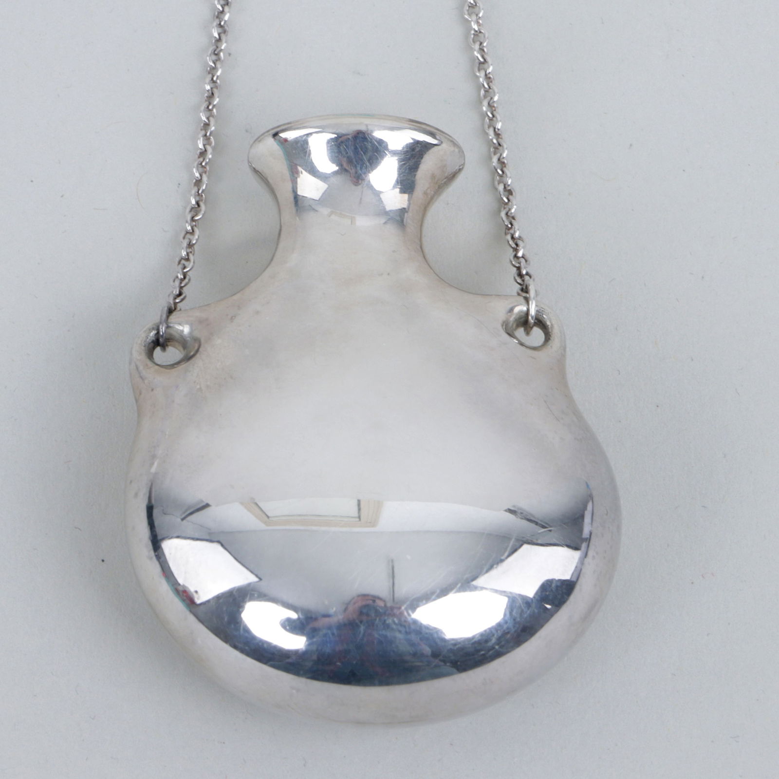 Elsa Peretti for Tiffany & Co: Elsa Peretti for Tiffany & Co. Sterling Silver "Open Bottle" Pendant Necklacehaving bottle-form pendant on a fine cable chain, marked on back of pendant and next to clasp; along with Tiffany & Co. dra