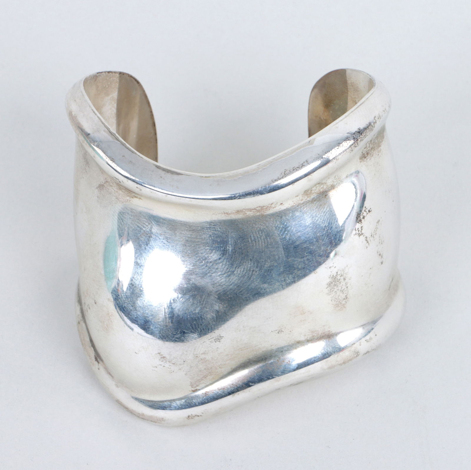 Elsa Peretti for Tiffany & Co.: Elsa Peretti for Tiffany & Co. Sterling Silver "Bone Cuff" Bracelet1975, signed, marked, and dated inside; along with Tiffany & Co. pouch, box, ribbon, and partial receipt.Inner circumference 6 1/4 in