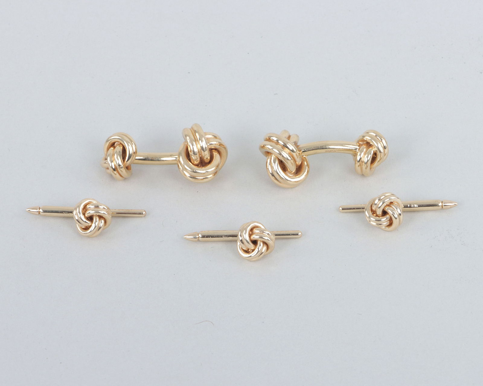 Tiffany & Co. 14k Gold Knot Cufflink and Button Stud Set: Tiffany & Co. 14k Gold Knot Cufflink and Button Stud Setto include: pair of cufflinks; and (3) spring-back button studs; along with a Tiffany & Co. box. All pieces marked.Total approximate weight 18.1