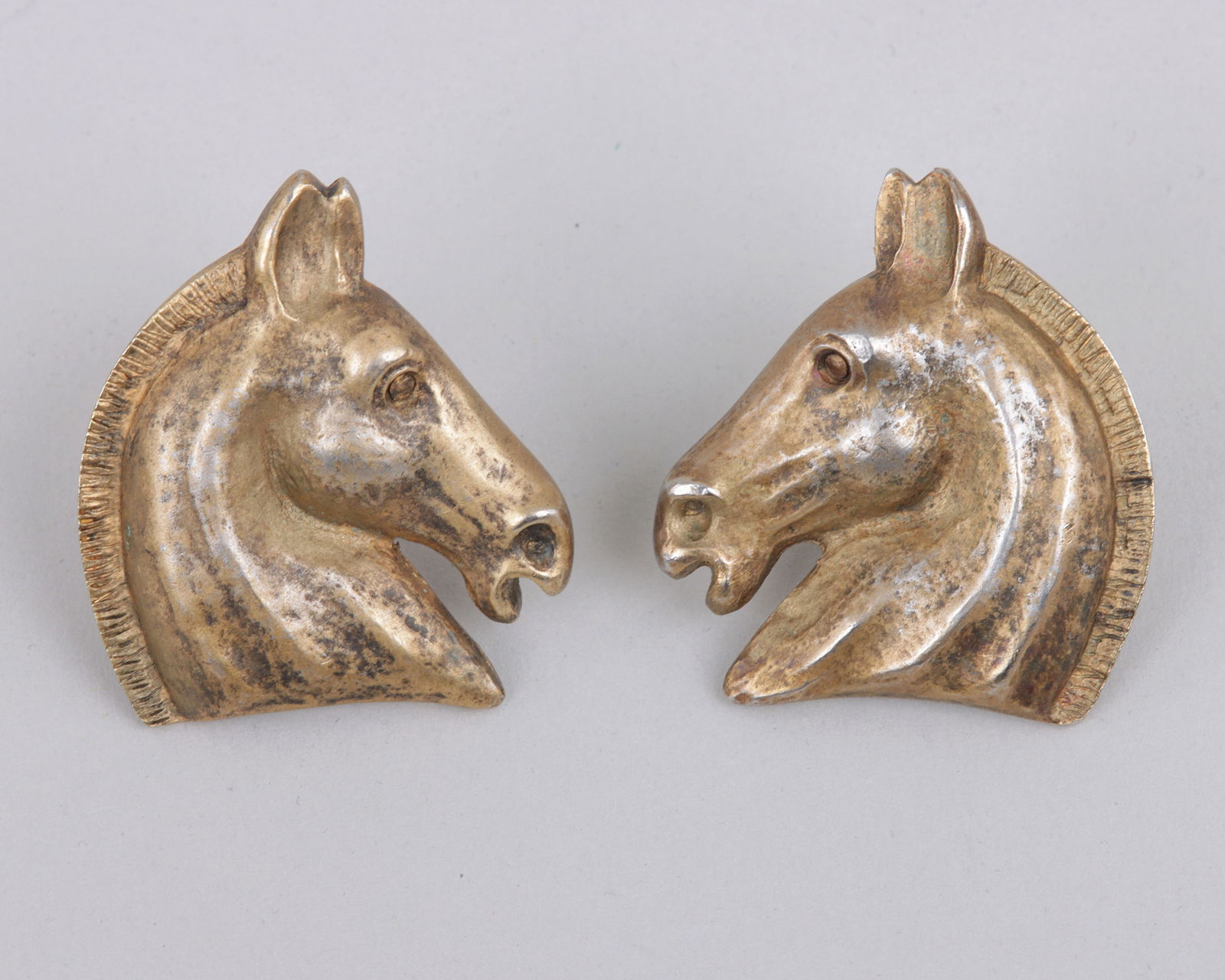 Pair of Hermes "Cheval" Horse Head Earrings: Pair of Hermes "Cheval" Horse Head Clip Earringsmarked "Hermes Paris, Bijouterie Fantaisie" on backs; along with an Hermes box.Earring 1 3/8 x 1 1/4 in. (3.5 x 3.2 cm.)