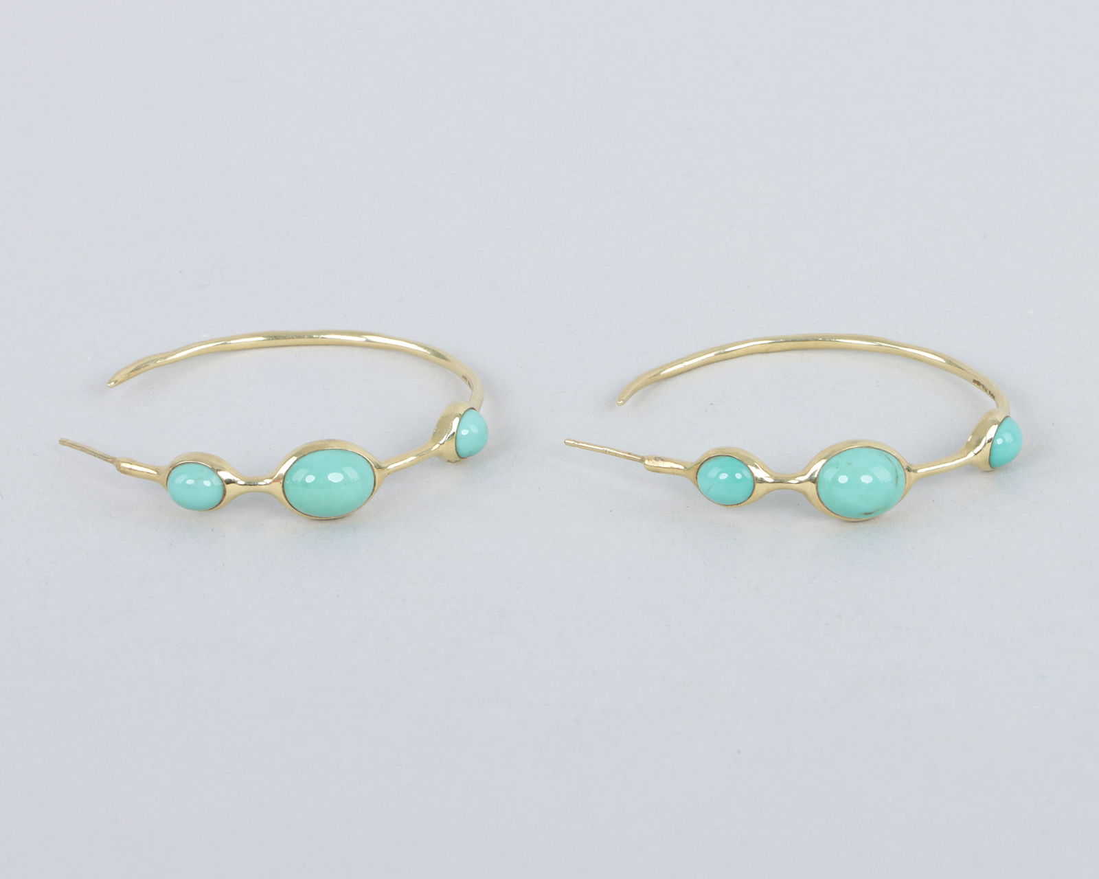Pair of Ippolita 18k Gold Turquoise Hoop Earrings: Pair of Ippolita 18k Gold Turquoise Hoop Earringspossibly from the Rock Candy collection, each having (3) oval turquoise cabochons of graduated size, marked inside.Diameter 1 1/2 in. (3.8 cm.); total
