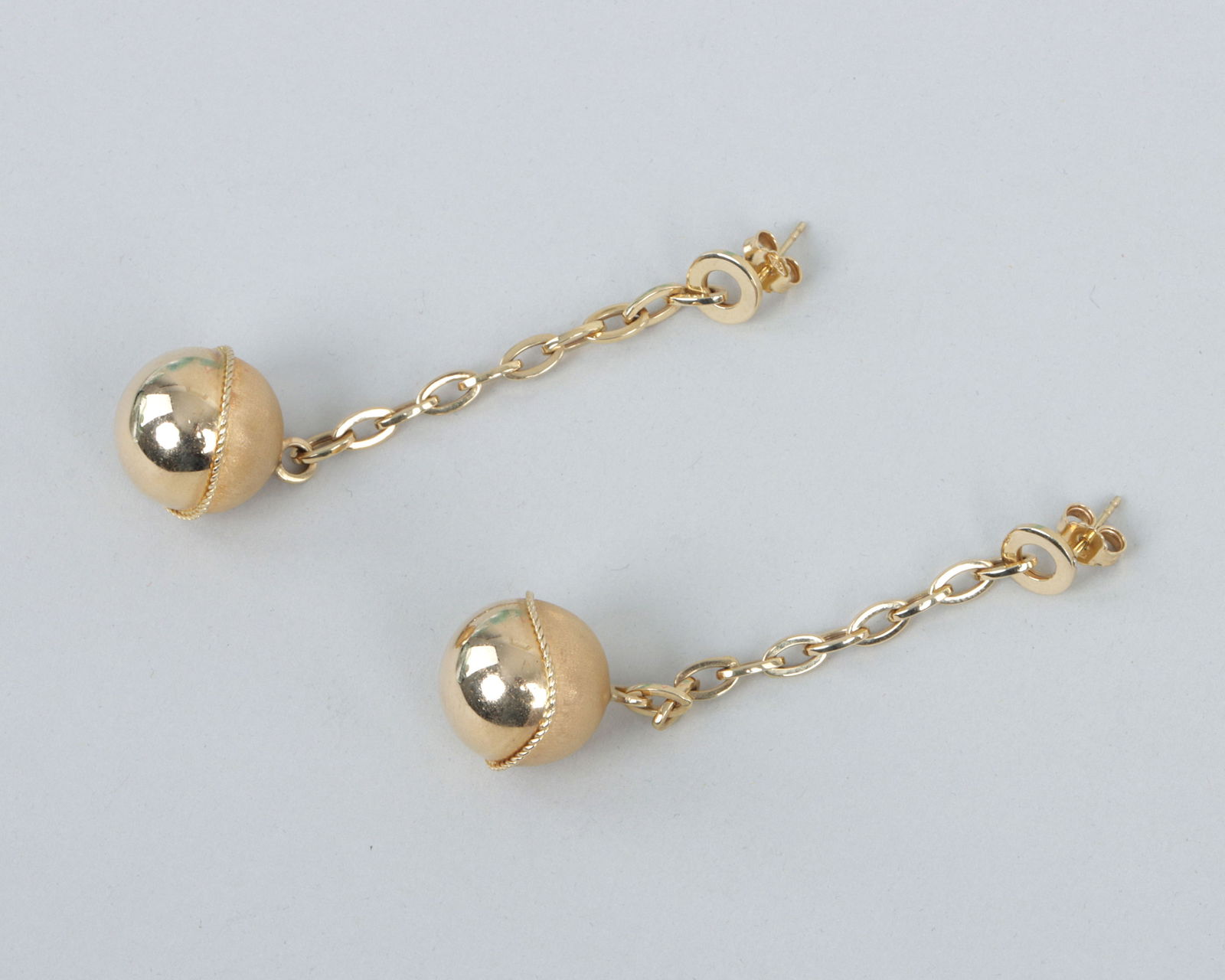 Pair of 18k Gold Drop Earrings: Pair of 18k Gold Drop Earringseach having a gold sphere with textured top half and applied rope twist, suspended from a pierced round stud by a cable chain, Italy, marked on backs of studs.Length 2 5/