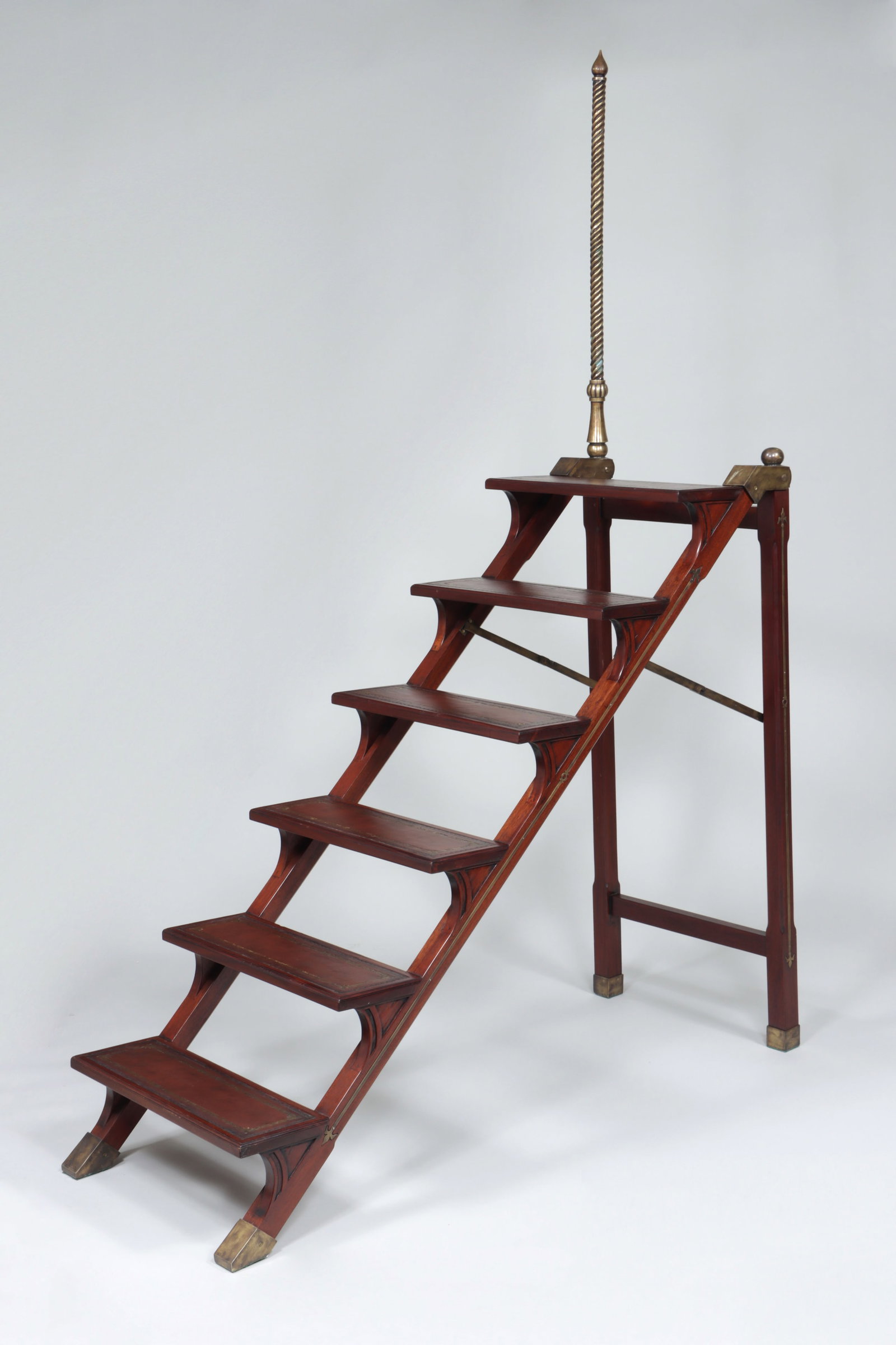Mahogany Library Steps: Mahogany Library Steps with gilt-tooled leather step insets, inlaid brass designs and support pole, as well as brass caps, plaque marked "Victorian Collection". 88 x 23 3/4 x 59 3/4 in. (223.5 x 60.3 