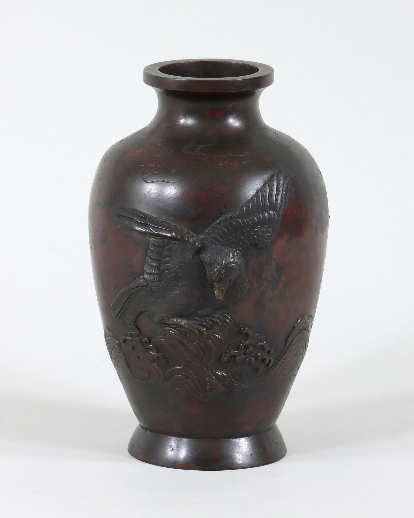 Japanese Meiji Bronze Vase: Japanese Meiji Bronze Vase relief-decorated with eagles over crashing waves, front having spread-wing eagle with gilt beak and gilt talons perched on a rock, reverse with pair of eagles flying over wa
