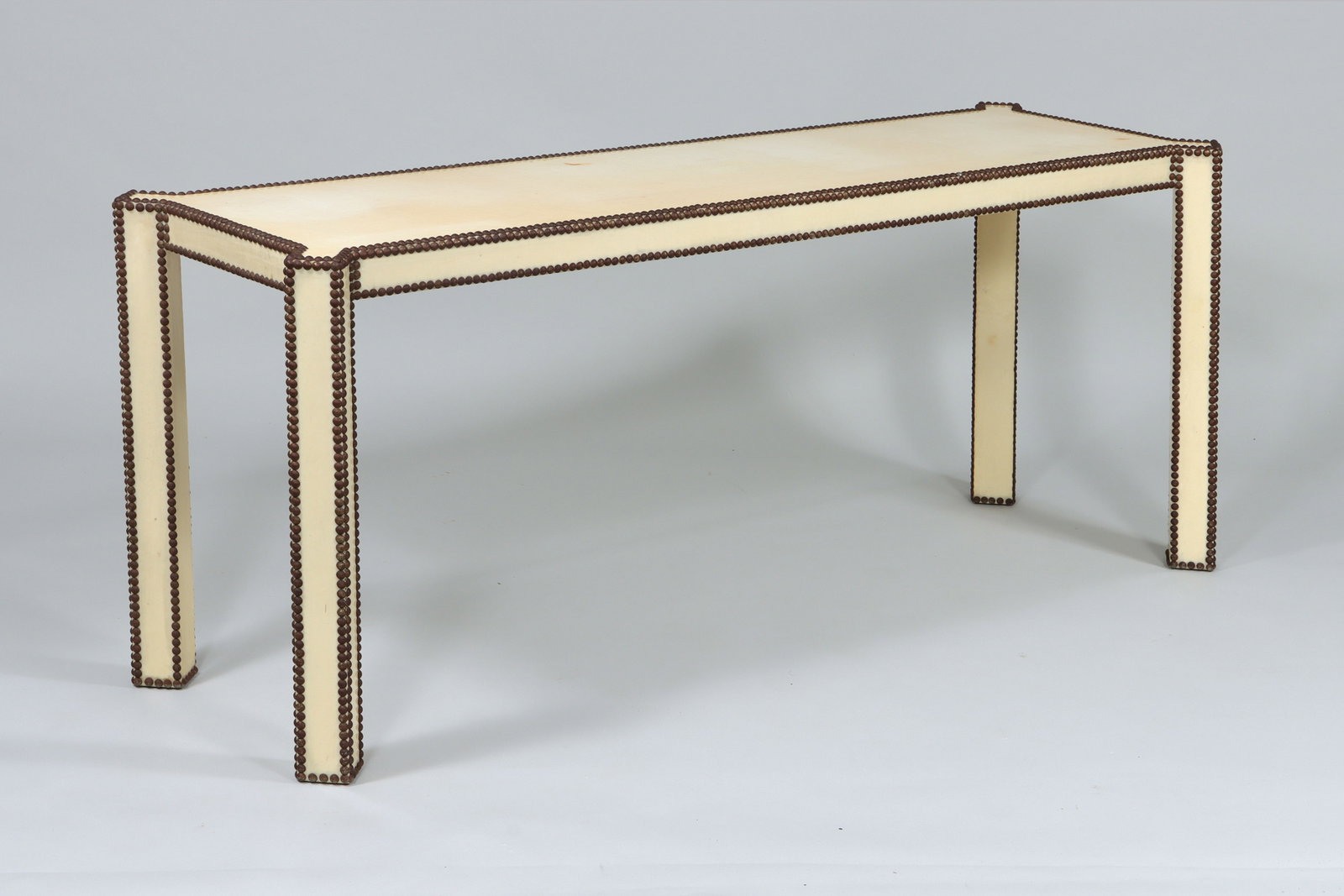 Midcentury Modern Console Table: Midcentury Modern Console Table faux skin-wrapped with tack edge. 26 1/4 x 64 1/4 x 20 in. (66.7 x 163.2 x 50.8 cm.)