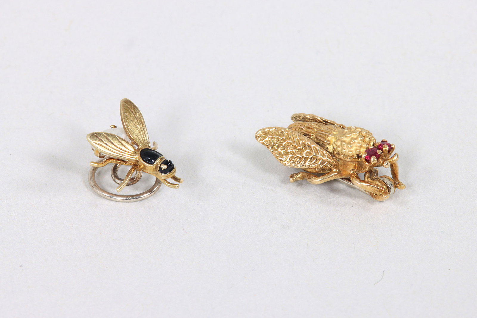 Group of (2) Gold Insect Jewelry: Group of (2) Gold Insect Jewelry to include: 18k pin with ruby eyes, France, hallmarked; and 14k hair charm with enamel decoration and freshwater pearl for body, marked. Pin 0.75 in. (1.9 cm.); total 