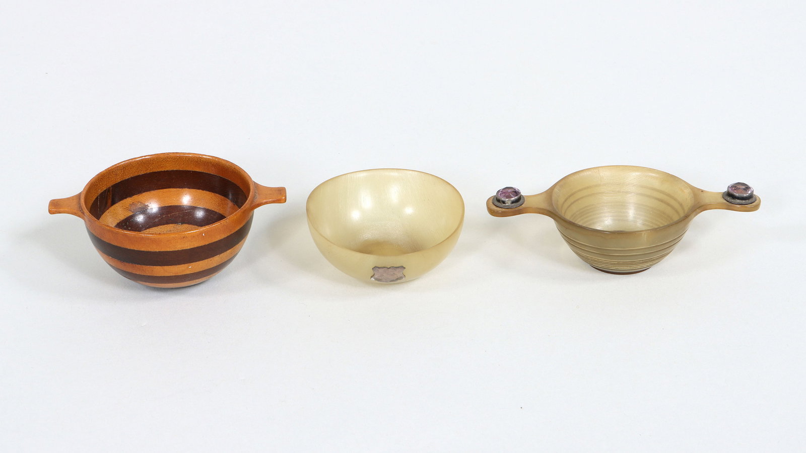 Scottish Quaichs: Group of (3) Scottish Quaichs to include: sterling silver-mounted horn quaich with amethyst, probably William Robb, Edinburgh, 1911, the carved horn body having twin handles with round-cut amethysts i