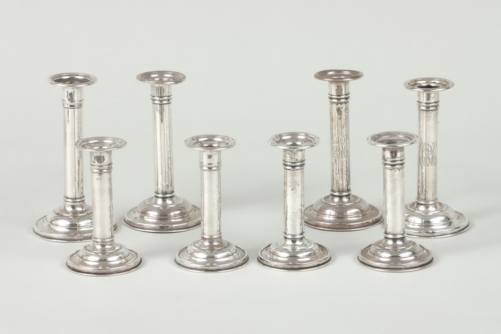 Gorham Sterling Silver Candlesticks: Group of (8) Gorham Sterling Silver Candlesticks weighted, all in the same pattern, of varying sizes, to include: set of (4) short candlesticks; pair of tall candlesticks with engraved script monogram