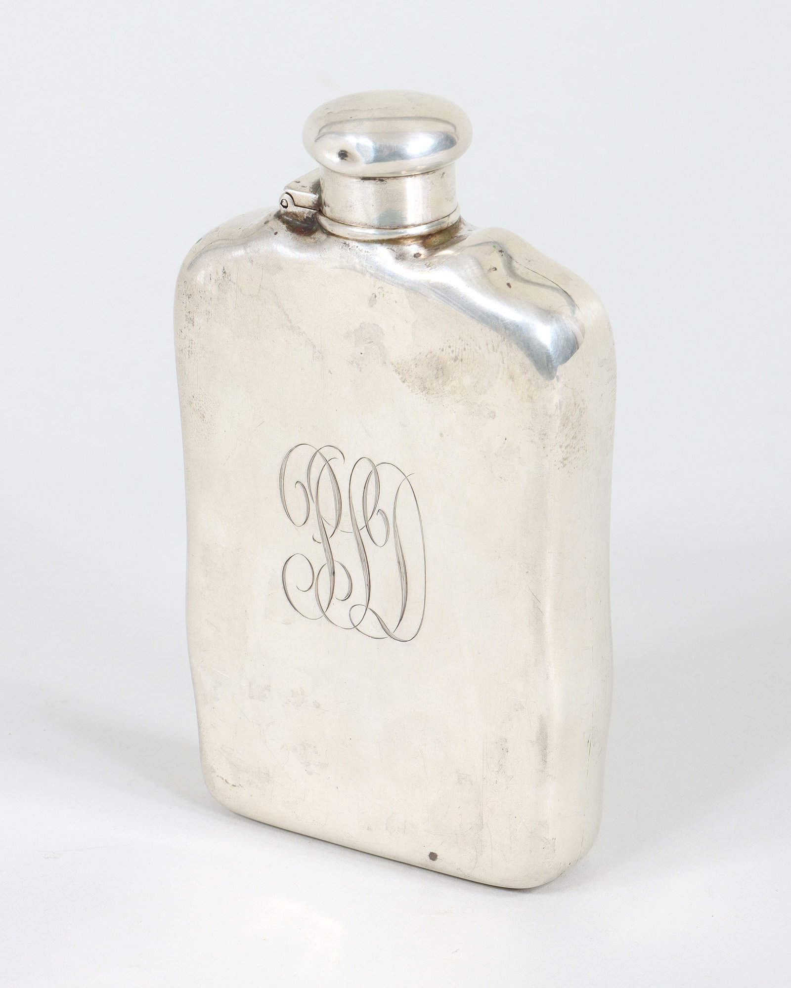 Tiffany & Co. Makers Sterling Silver Flask: Tiffany & Co. Makers Sterling Silver Flask c. 1892-1902, with hinged screw-top, monogrammed on side, marked on bottom. 5 5/8 x 3 1/4 x 1 in. (14.3 x 8.3 x 2.5 cm.); approximate weight 7.0 troy oz. (21
