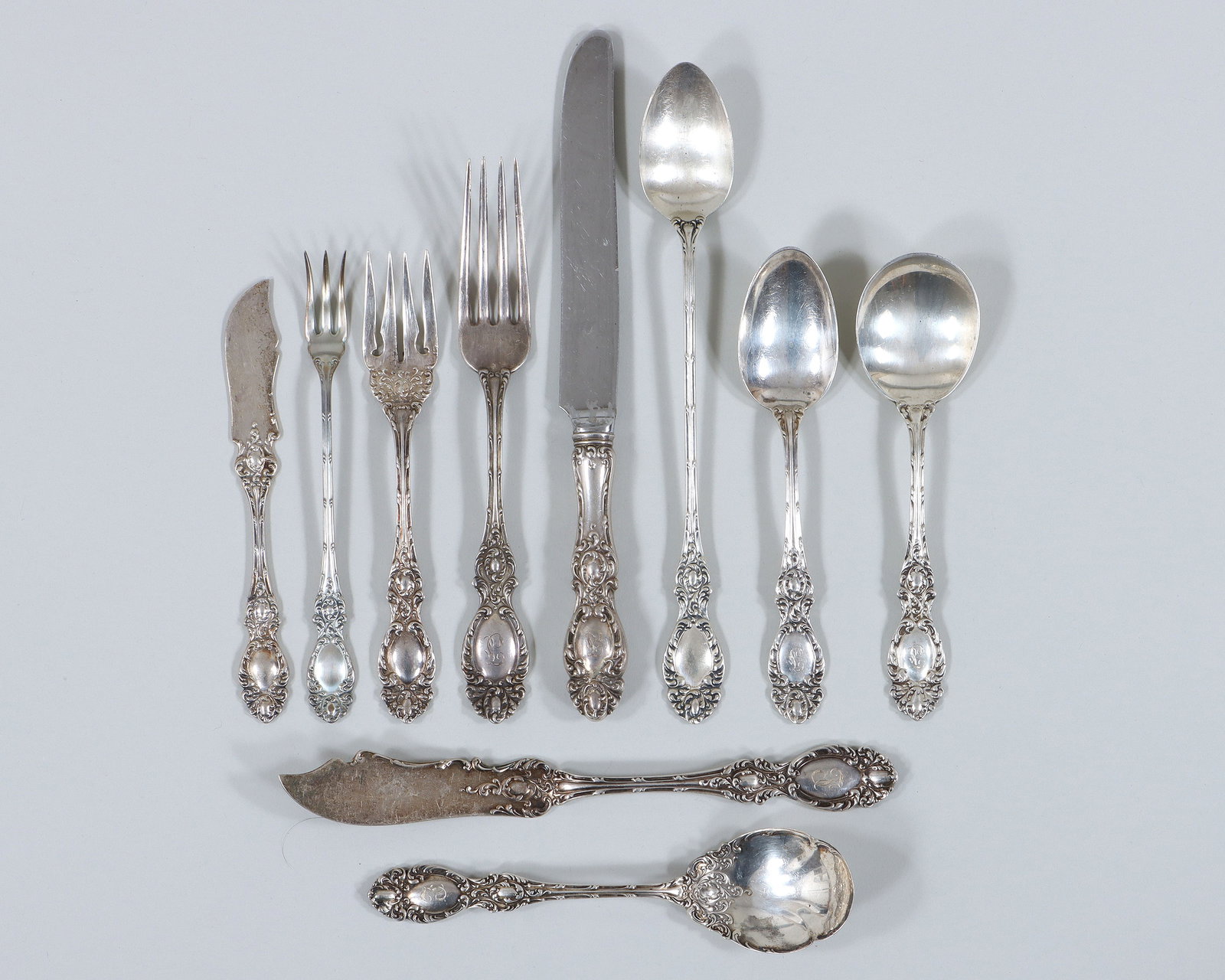 American Sterling Silver Flatware Service: American Sterling Silver Flatware Service in the Lucerne pattern, R. Wallace & Sons. Mfg. Co., Wallingford, CT, to include: (4) dinner forks; (7) sterling-handled dinner knives; (7) salad forks; (5) c