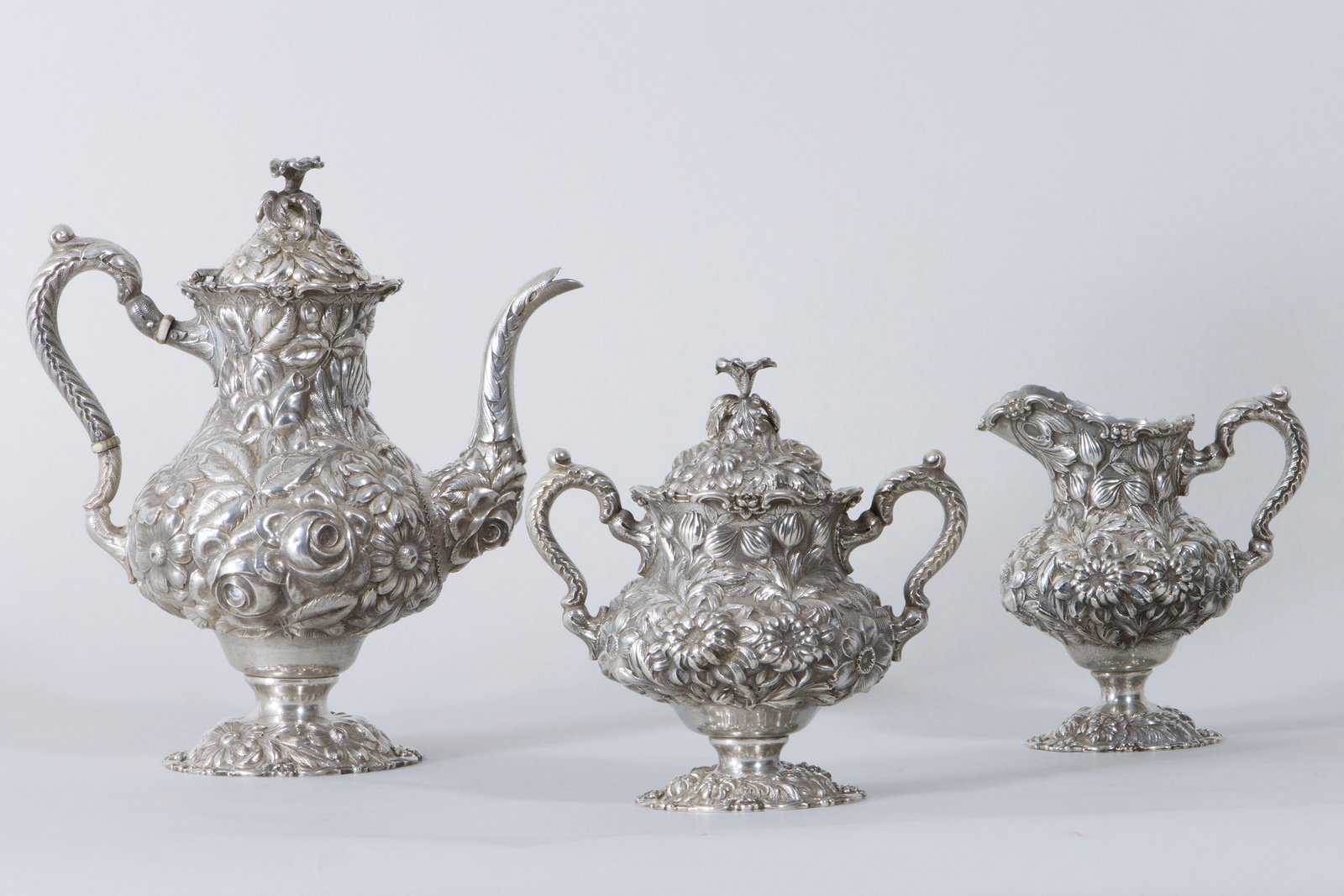 Sterling "Stieff Rose" Three-Piece Tea Set: American Sterling Silver "Stieff Rose" Three-Piece Tea Set in a variation of the Stieff Rose pattern, The Stieff Company, Baltimore, MD, 1927, having repousse floral design, leaf-topped scroll handles