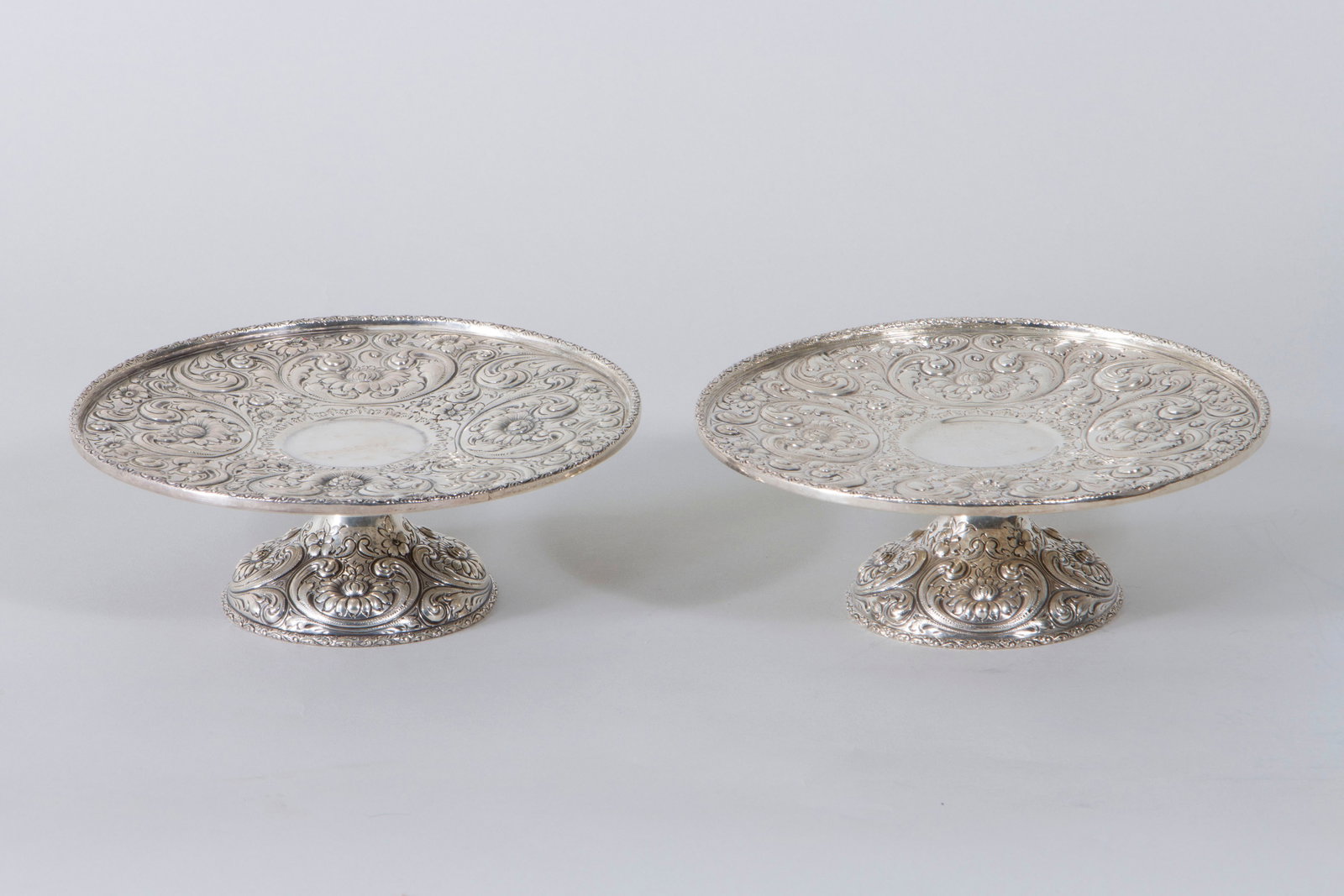 Howard & Co., New York, NY, 1900: Pair of American Rococo-Style Sterling Silver Tazzas Howard & Co., New York, NY, 1900 having repousse and chased floral and scrolled foliate design and molded rims with scrolled foliate design, marked