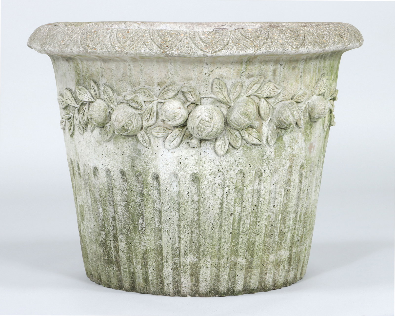 Large Cast Stone Wall Planter: Large Cast Stone Wall Planter with pomegranate relief decoration, leaf-and-dart rim, and reeded body, marked "Nina Sudio, Quakerstown, PA". 22 1/2 x 28 1/2 x 15 3/4 in. (57.2 x 72.4 x 40 cm.)