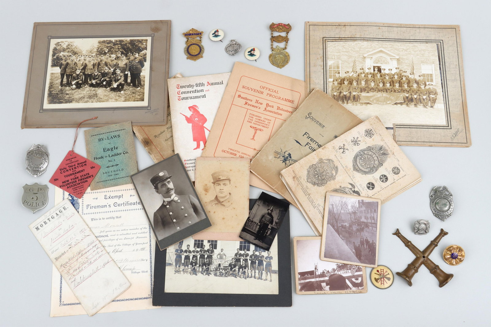 Firefighters Badges, Photographs, etc.: Group of (30) Firefighters Badges, Photographs and Ephemera, Long Island and New York City comprising (12) badges, (9) photographs, and (9) ephemera, late 19th/early 20th century Badges, mostly metal,