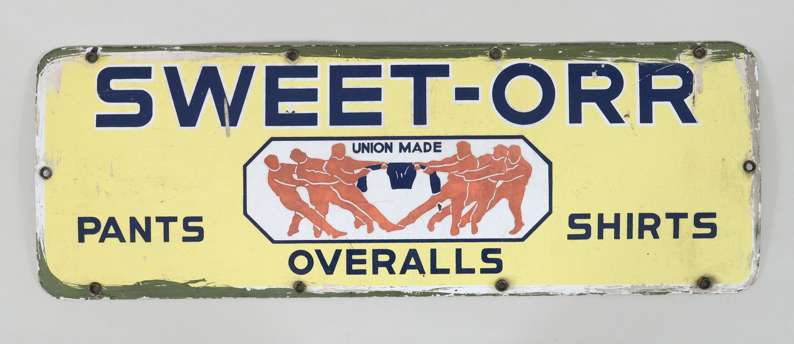 Sweet-Orr Porcelain Sign: Sweet-Orr Porcelain Advertising Sign having tug-of-war trademark at center, surrounded by company name and product names. 27 x 9 1/2 in. (68.6 x 24.1 cm.)