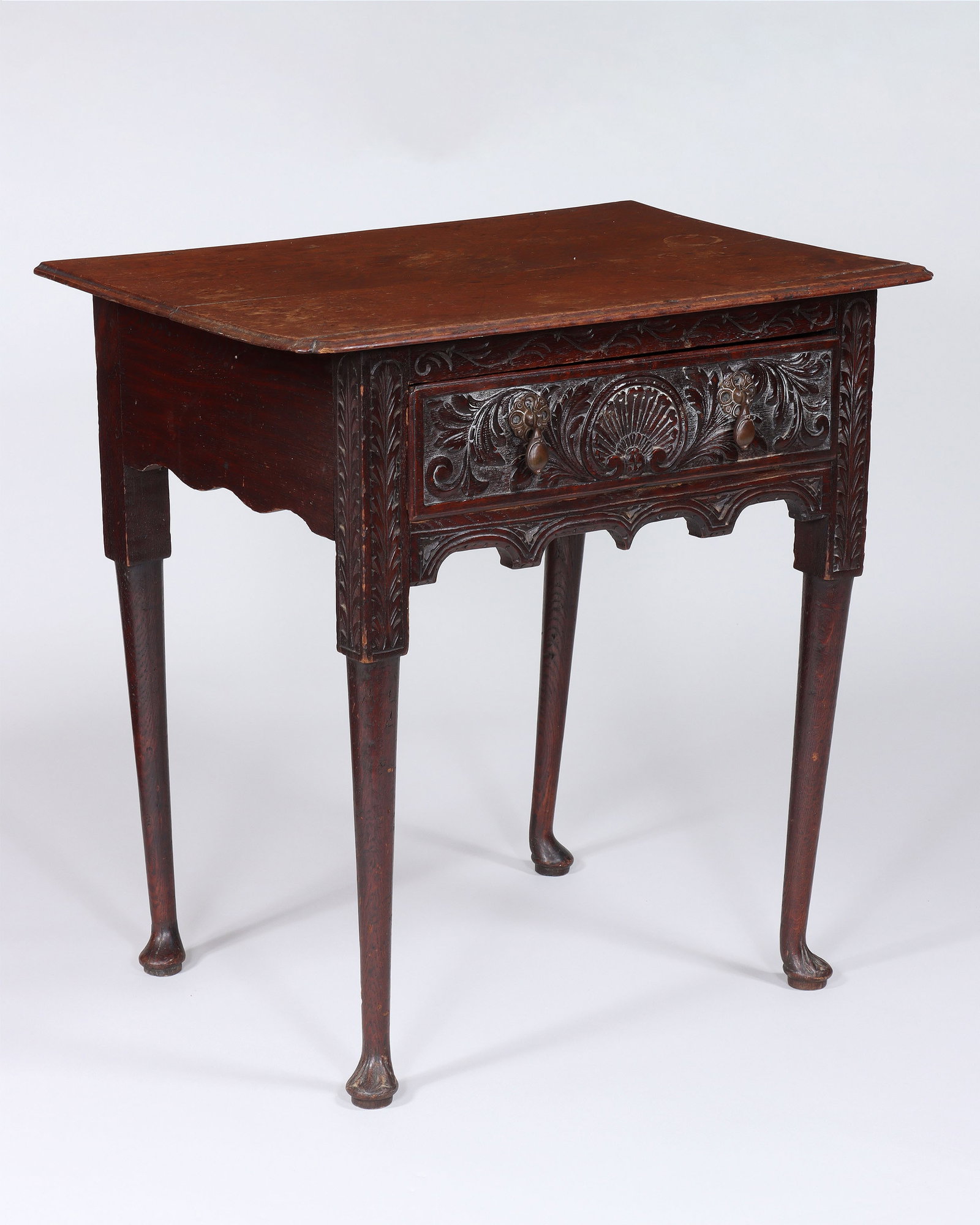 Georgian Table with Drawer: Georgian Table with Drawer the rectangular top with pinched corners, having a drawer with relief-carved central shell flanked by scrolled acanthus decoration, over a shaped and carved apron, on round 