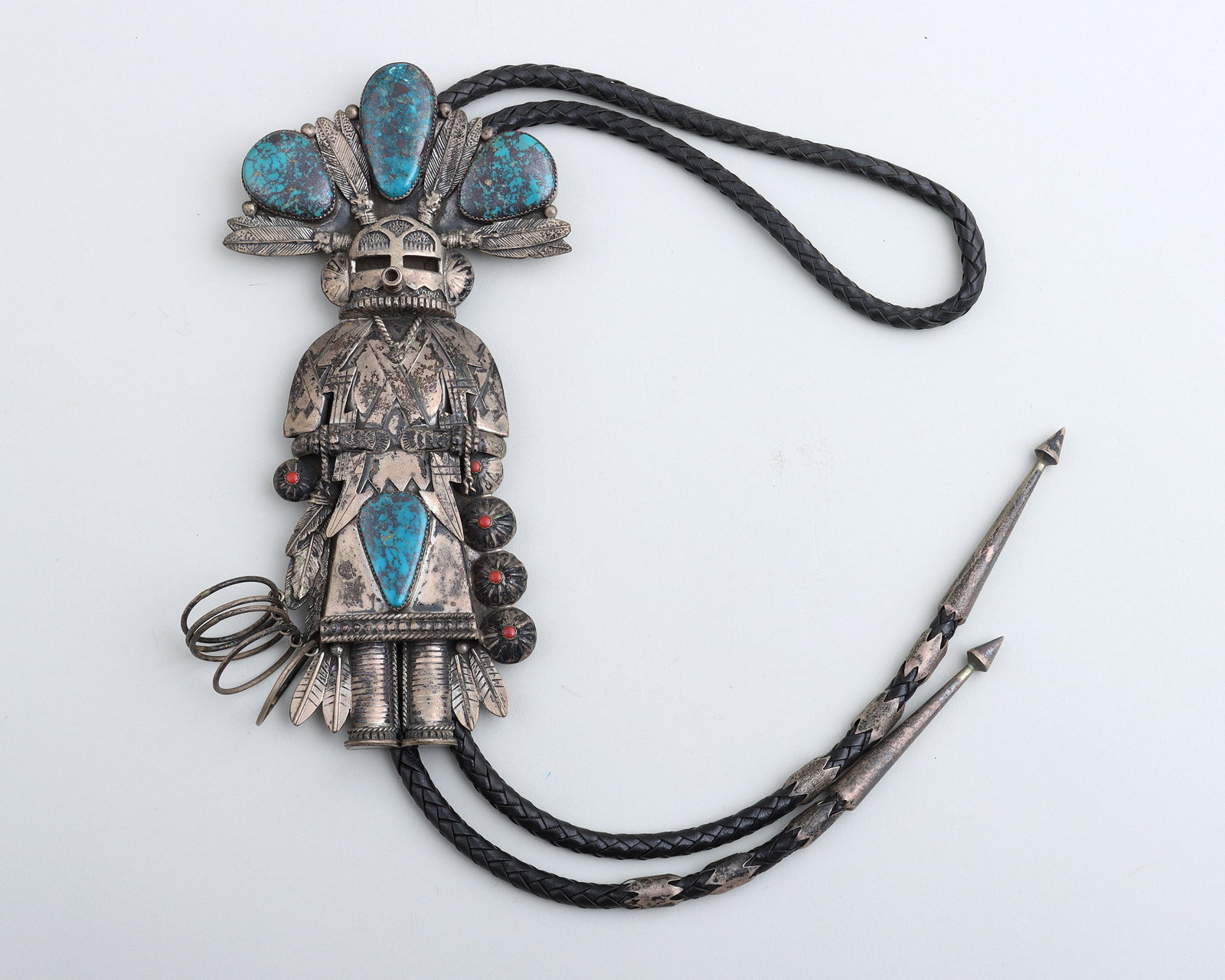 Jerry Roan (Dine (Navajo), 1919-1977): Jerry Roan Dine (Navajo), 1919-1977 Large Sterling Silver, Turquoise, and Coral "Hoop Dancer" Kachina Bolo Tie having a large sterling silver bolo in the form of a hoop dancer with (5) articulated hoo