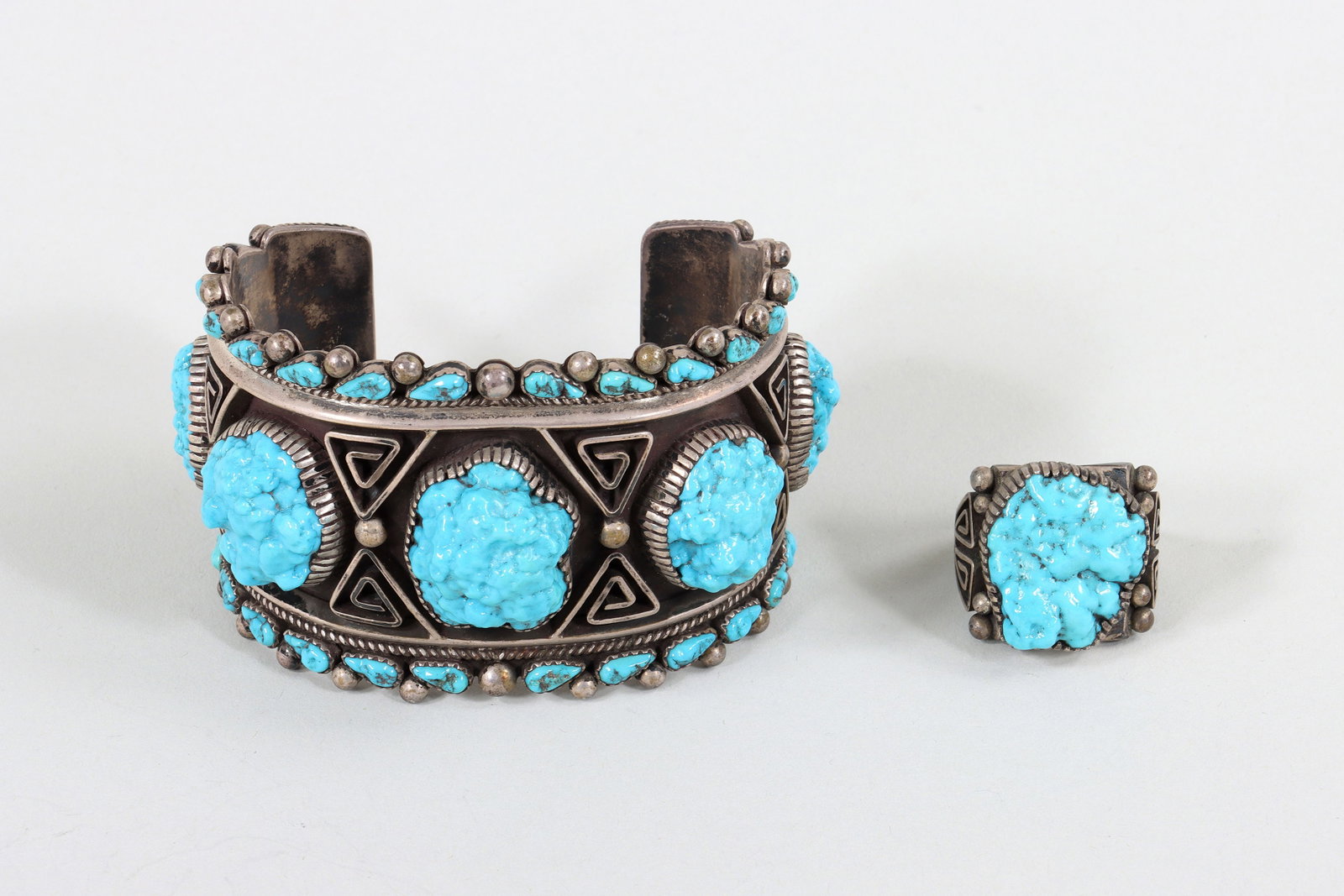 Bill and Betty Betony (Navajo, b. 1934): Bill and Betty Betony Navajo, b. 1934 Two-Piece Sterling Silver and Turquoise Jewelry Set with large turquoise stones in ribbed bezel settings, applied wirework triangular spirals, and applied silver 