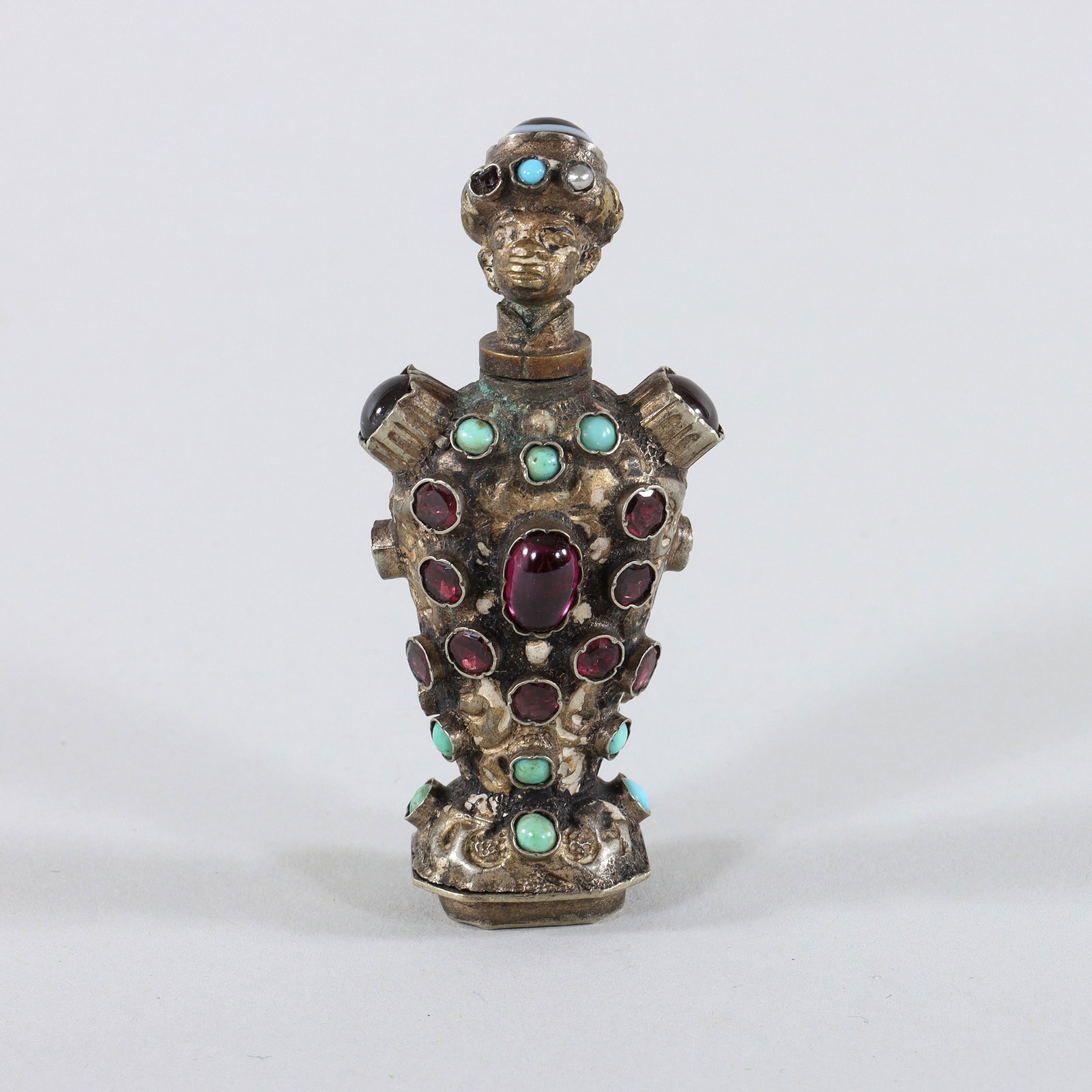 Continental Jeweled Figural Scent Bottle: Continental Jeweled Figural Scent Bottle in the form of a Moor, silverplate, having screw-top in the form of a head in a turban, with (4) semi-precious stones, comprising a large onyx bead, a seed pea