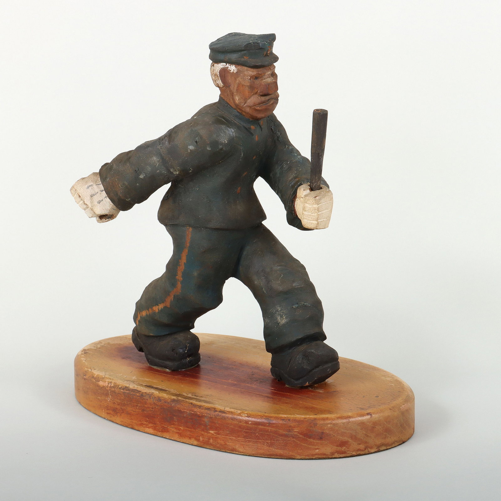 Folk Art Carved Policeman Figure: Folk Art Carved and Painted Wood Policeman Figure unsigned. Overall 13 x 13 x 7 1/2 in. (33 x 33 x 19.1 cm.)